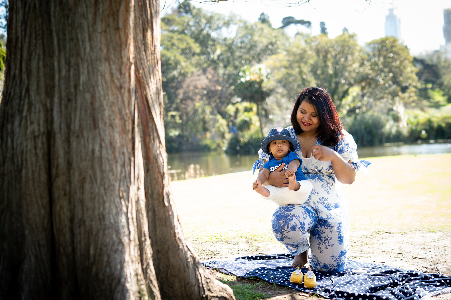Maternity portrait seated beside a large tree