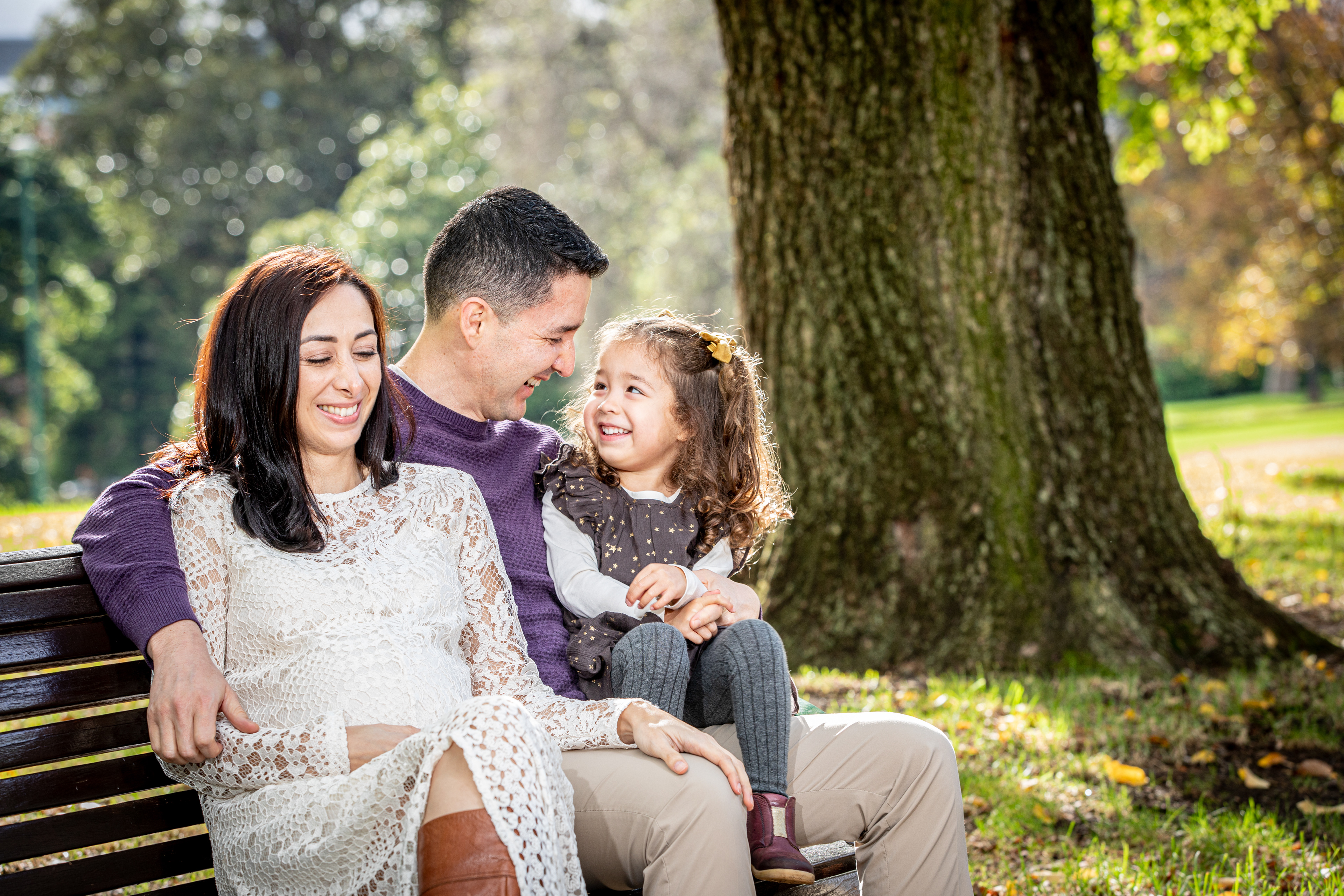 Family portrait seated on a park bench