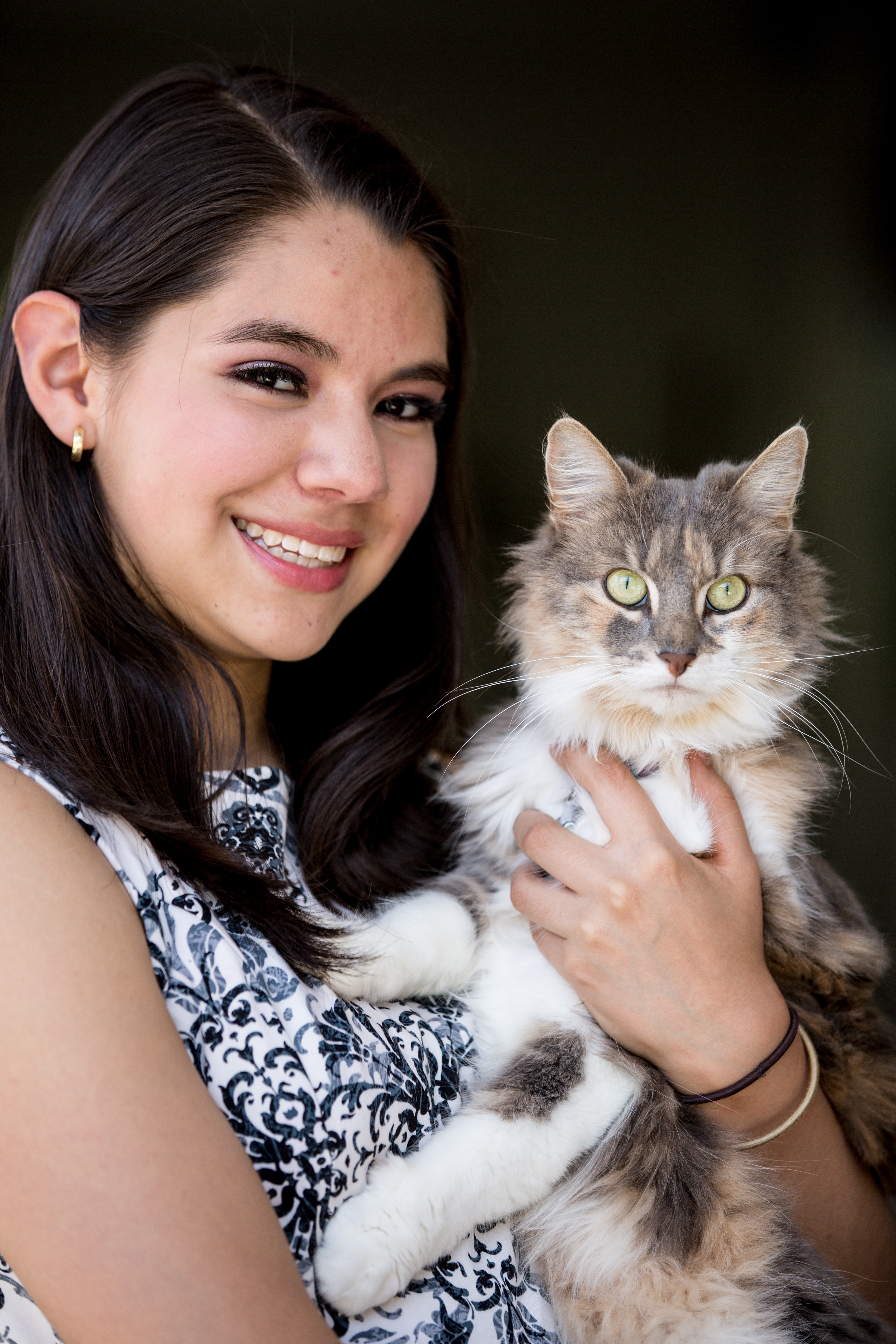 Portrait of a person holding a grey cat