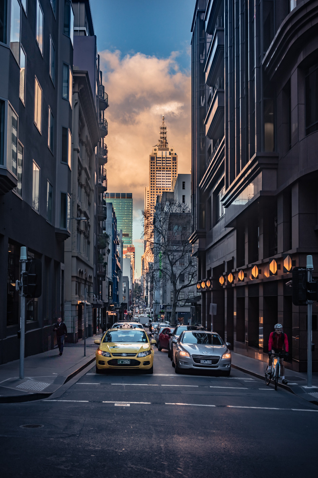 Narrow city street framed by tall buildings