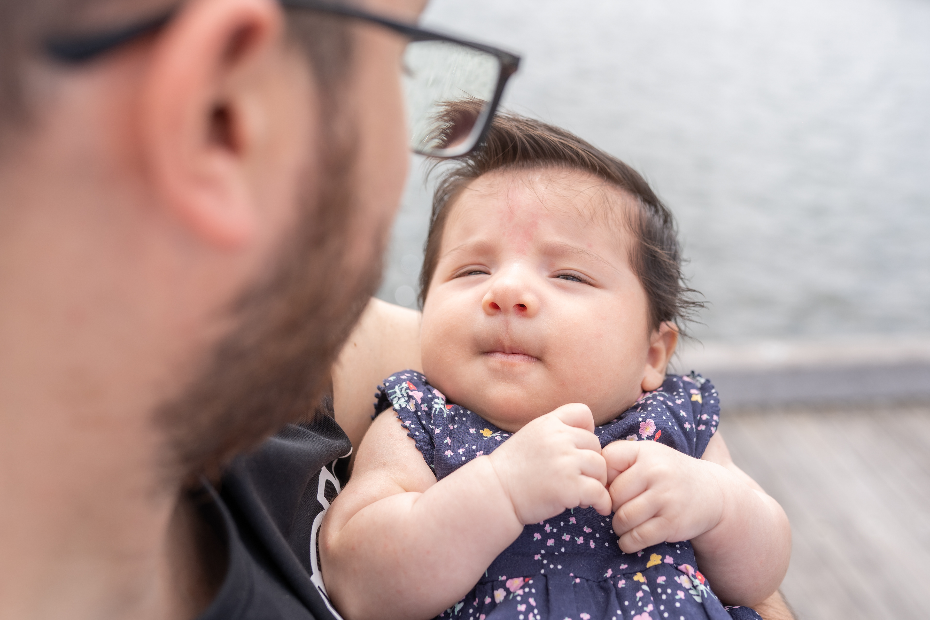 Close-up of a parent kissing a sleeping baby