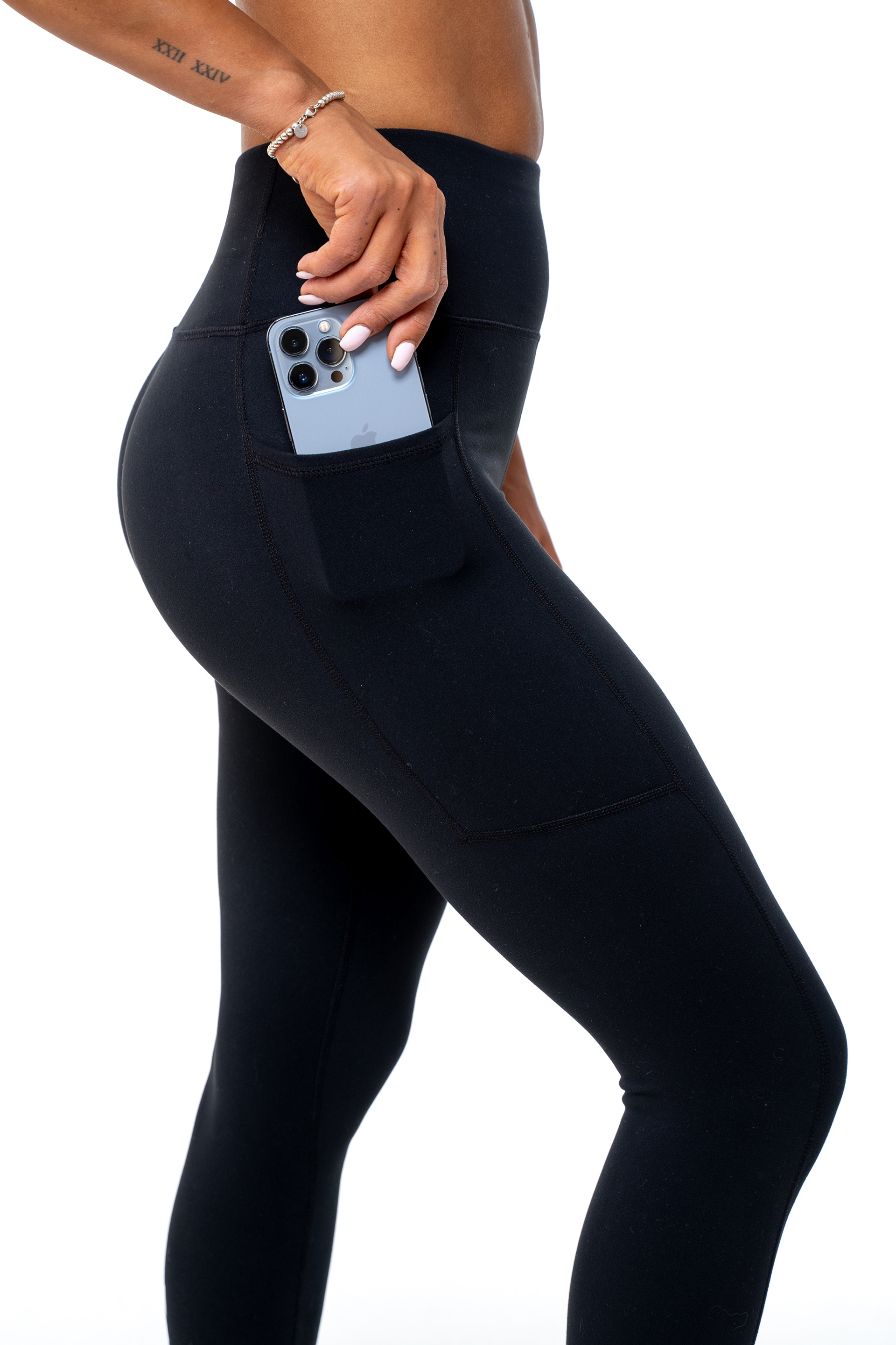 Person wearing black activewear with a waist bag