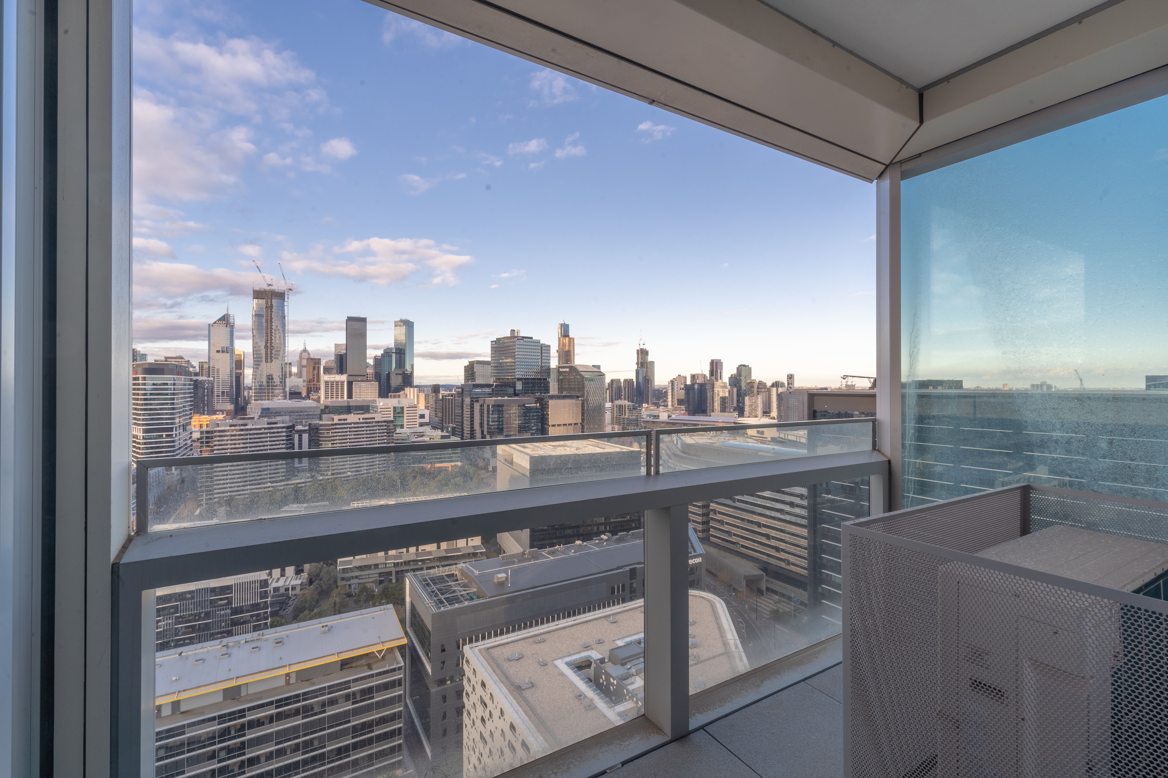 Apartment bedroom with a corner window and skyline views