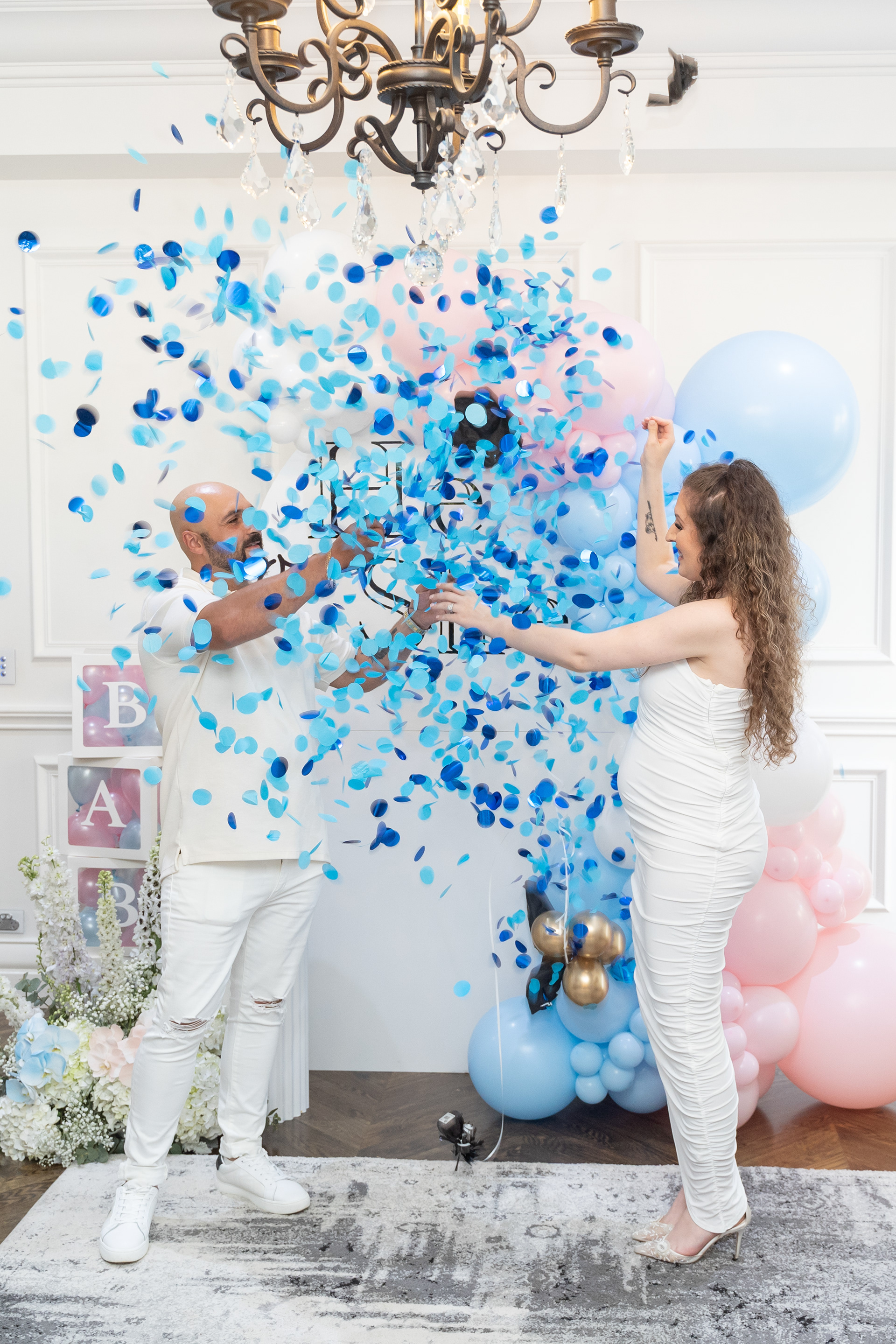 Blue confetti falling over a couple at a party