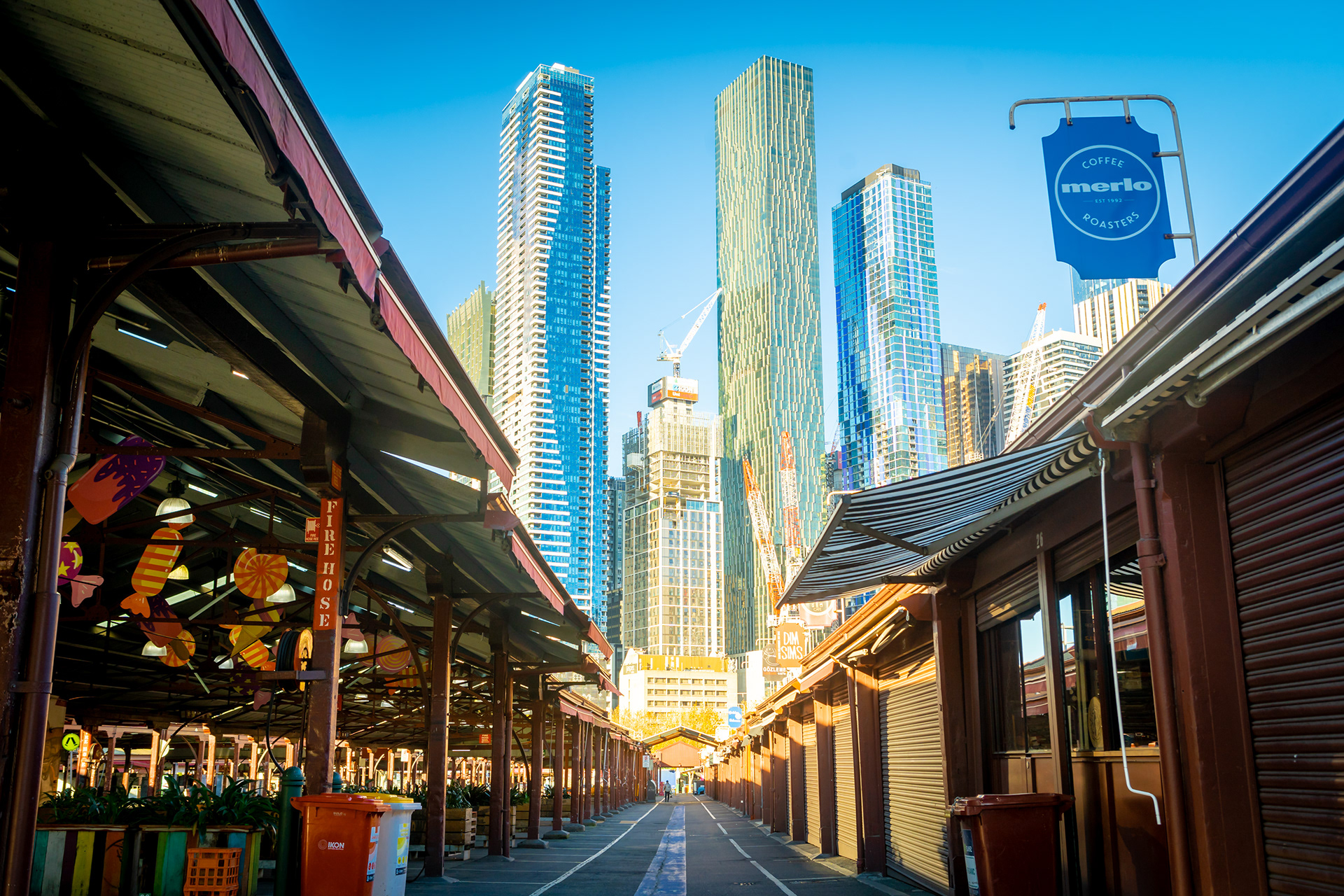 Skyscrapers rising above a covered market walkway