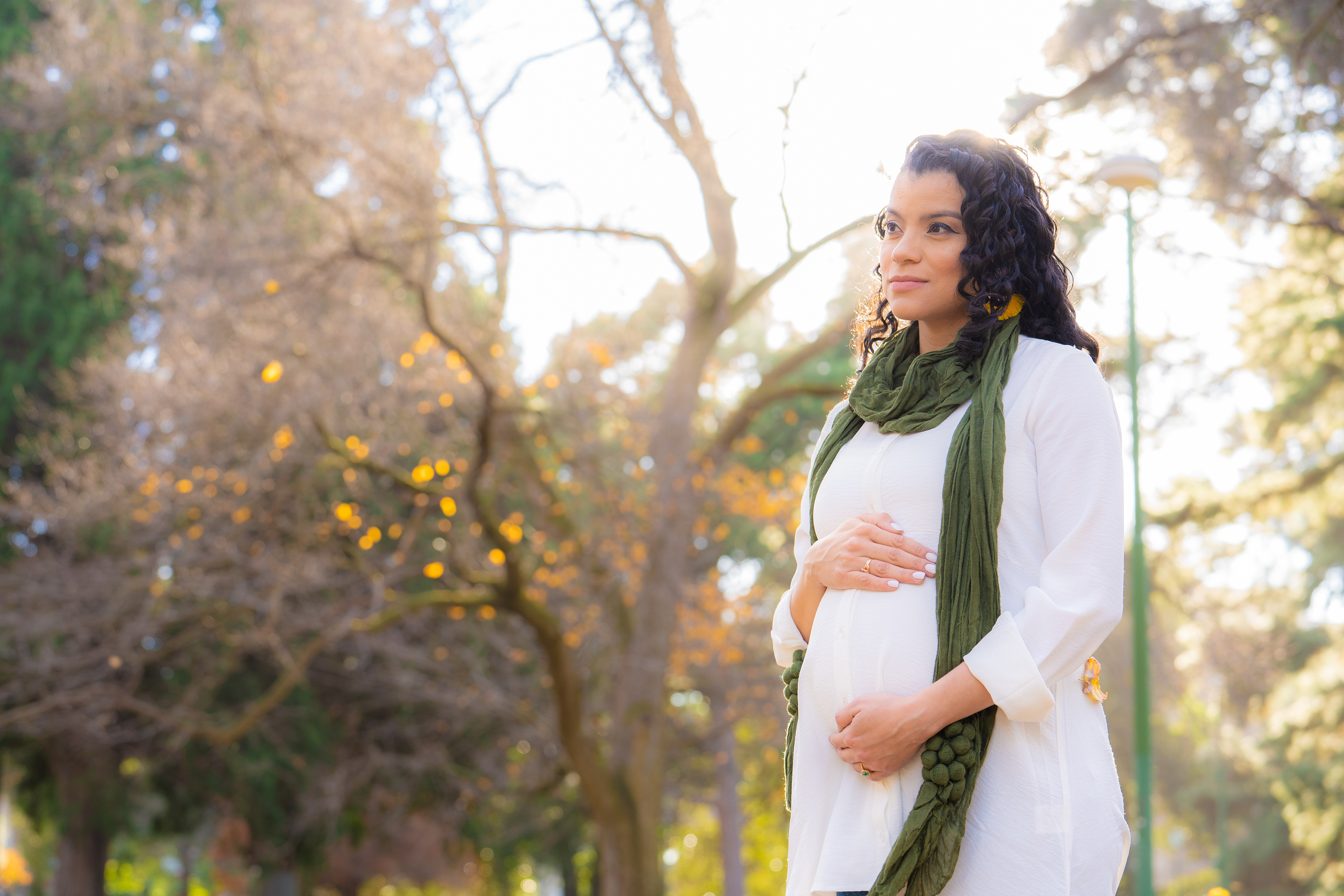 Maternity portrait among sunlit trees