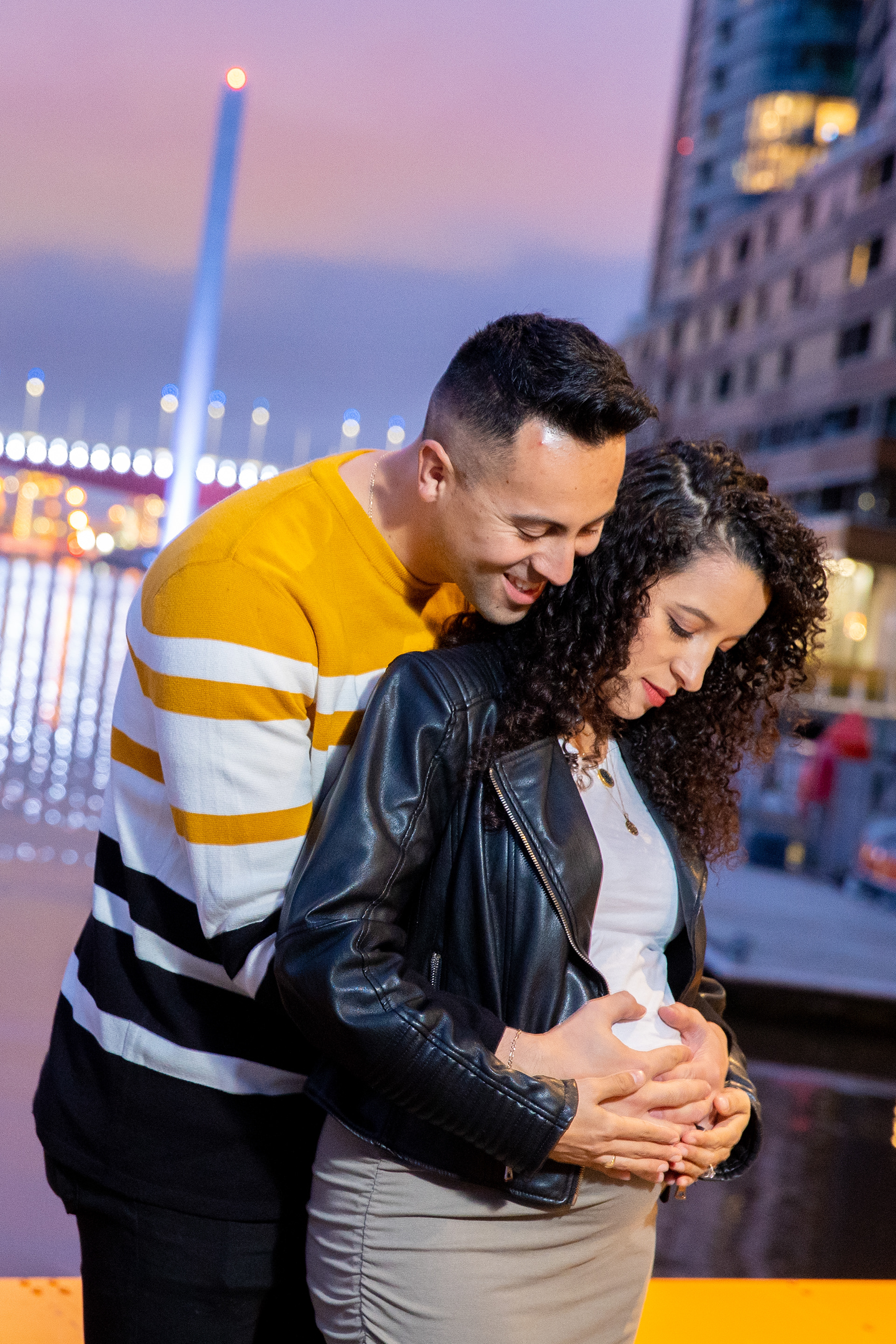Couple sharing a close embrace outdoors at dusk