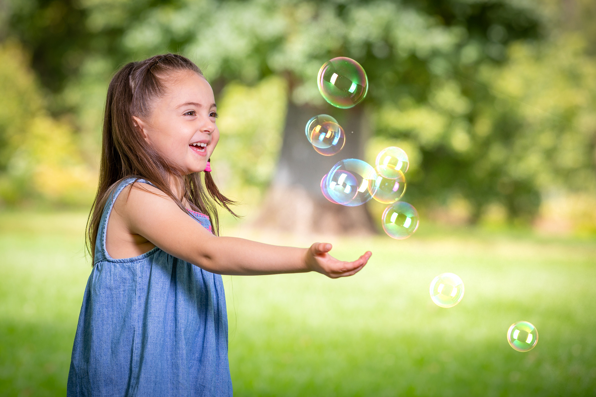 Child watching soap bubbles float through the air