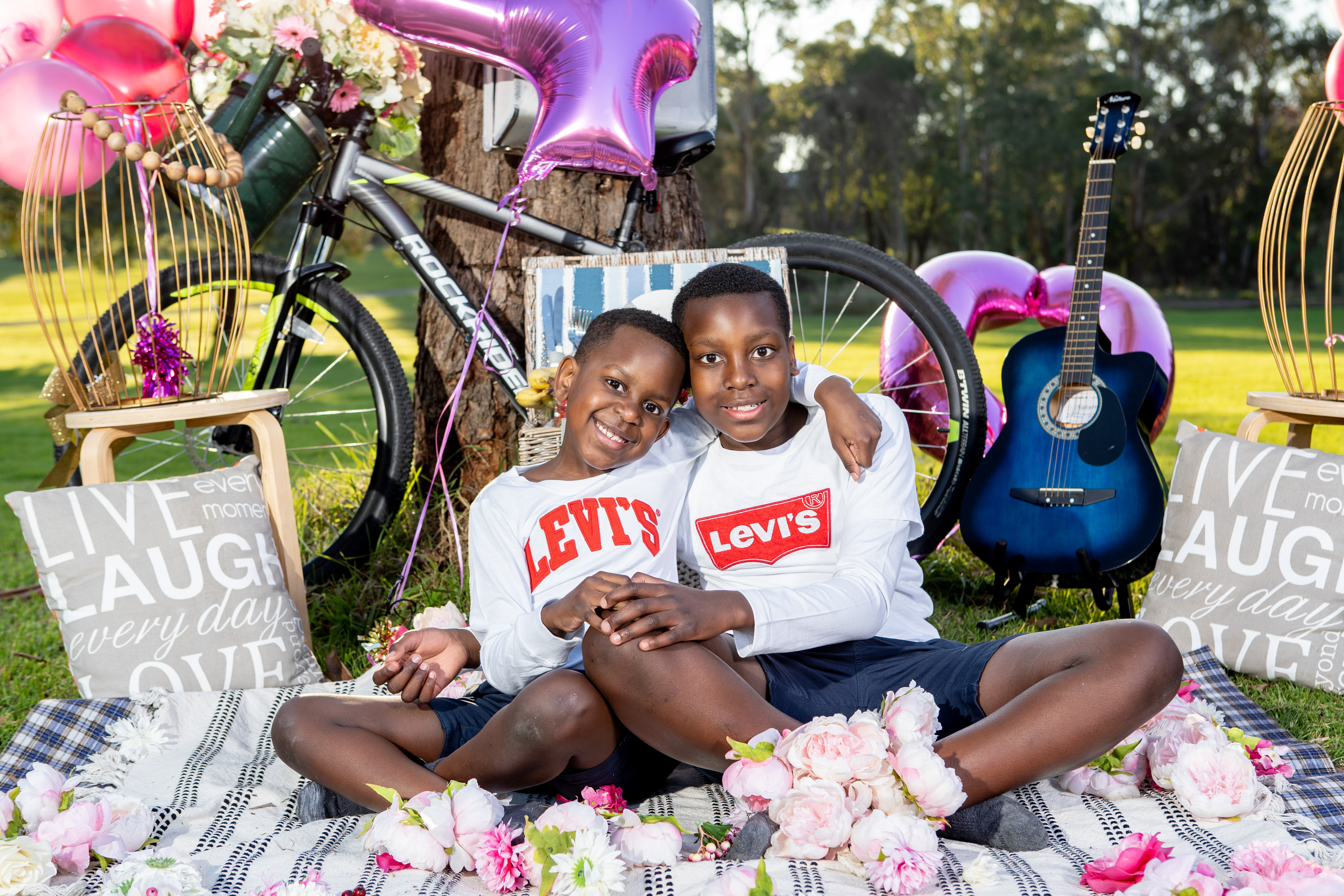 Family enjoying a picnic on a patterned blanket