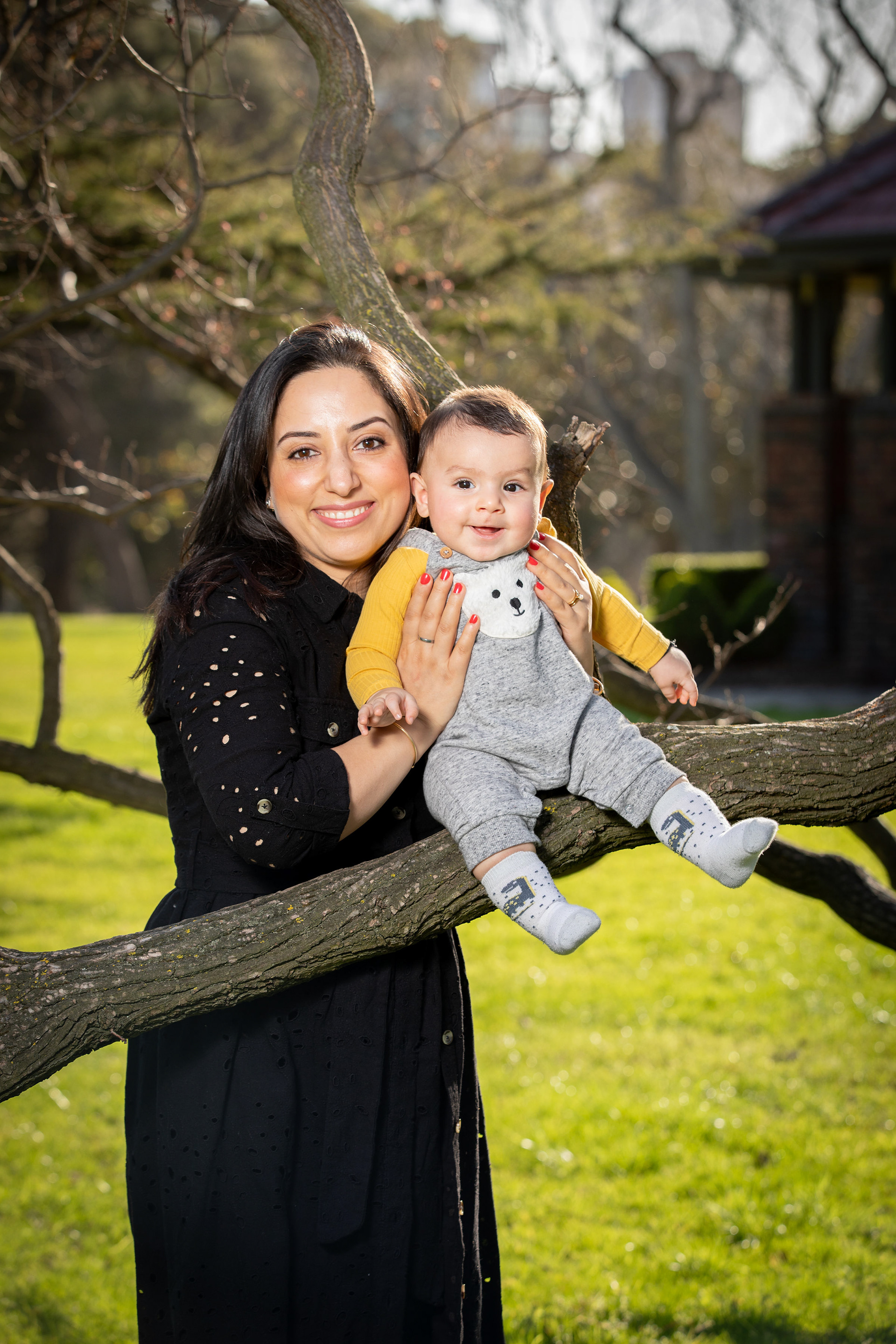 Parent and children smiling together in a park