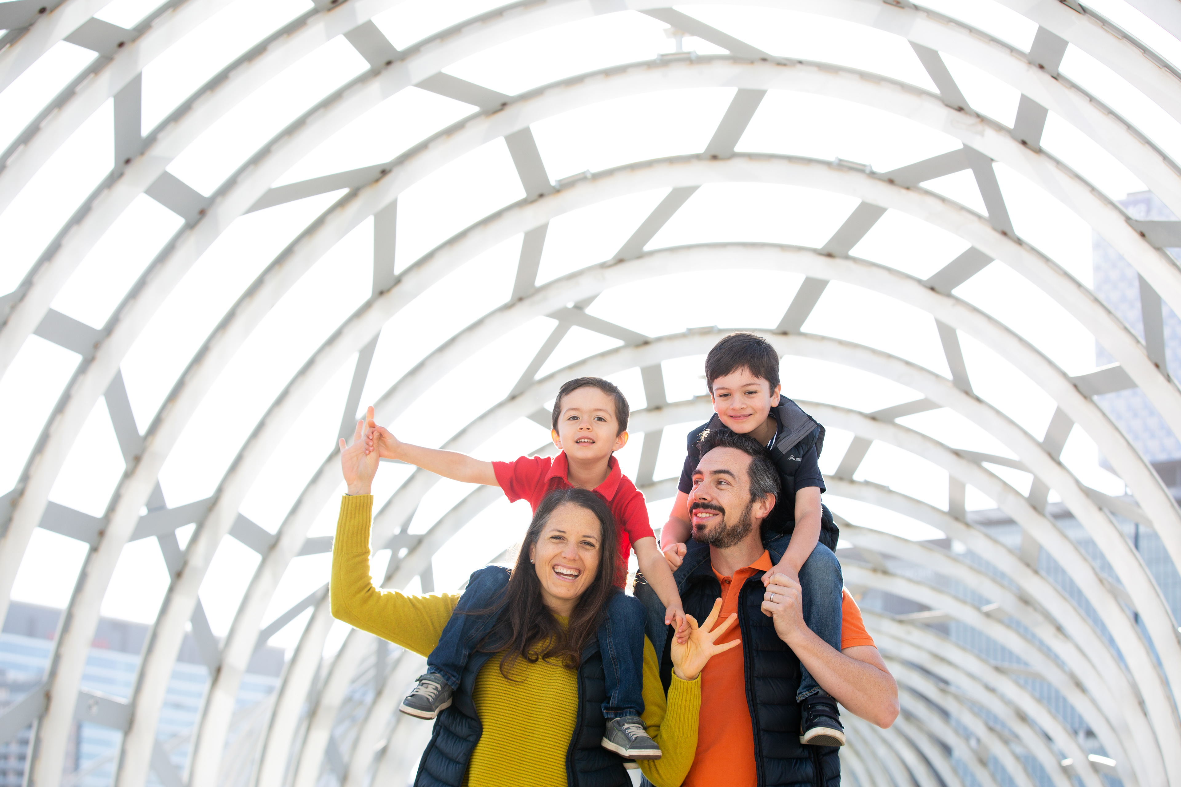 Two people posing beneath a curved station roof