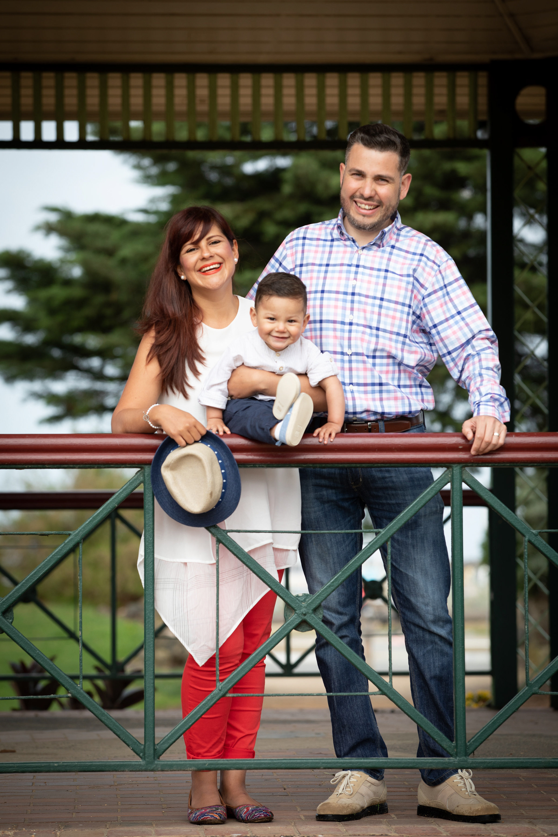 Couple posing on a garden bridge