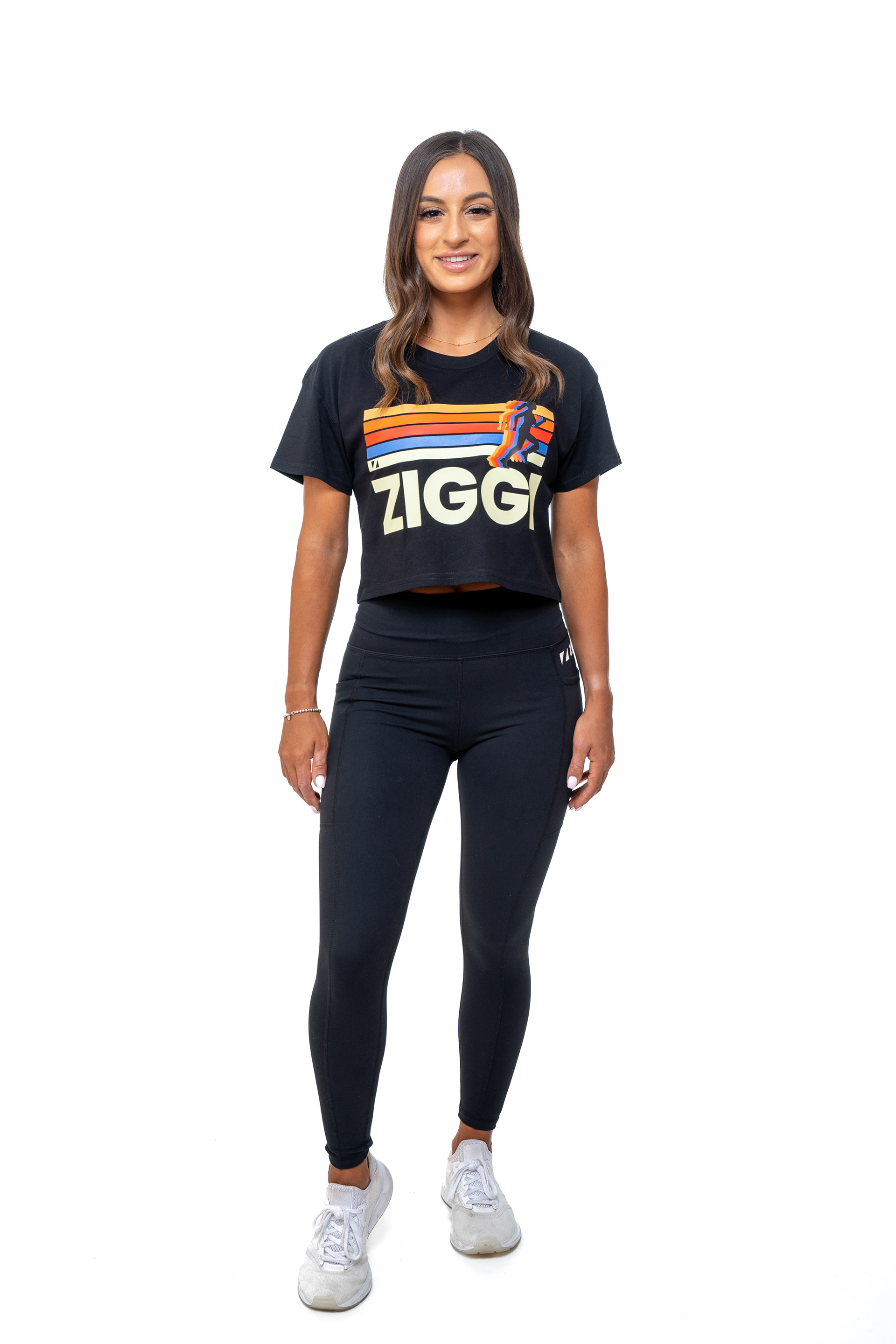 Full-length portrait in black activewear against white