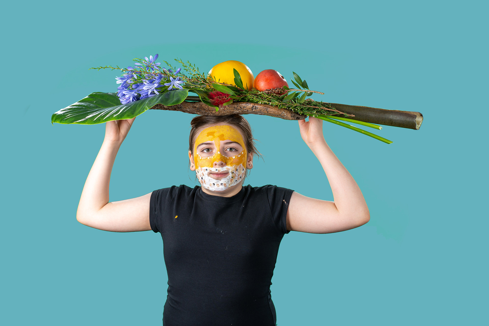 Portrait holding a frame decorated with colourful flowers