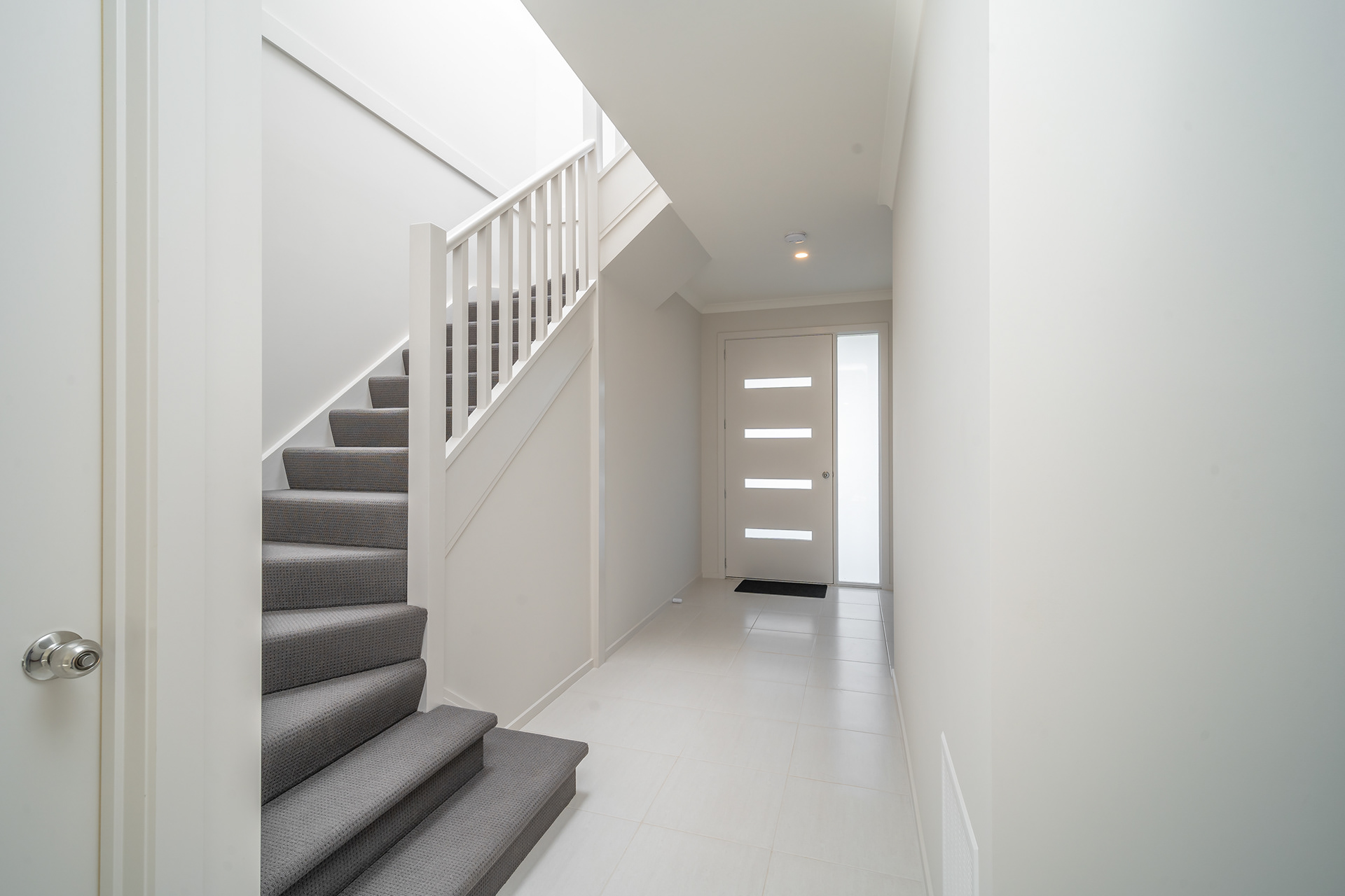 Bright entrance hall with a carpeted staircase