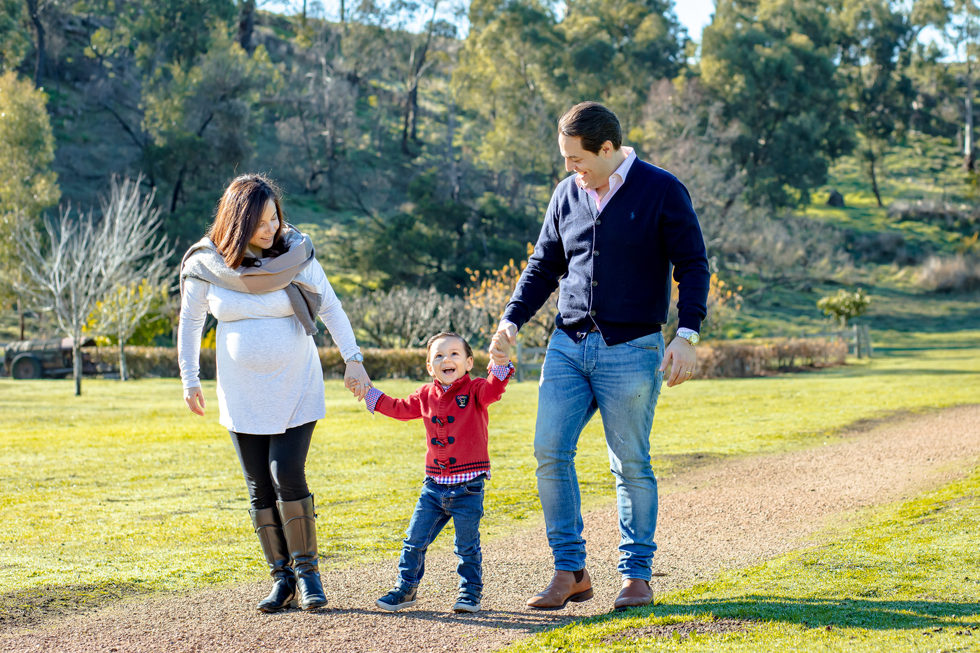 Family walking together across a grassy park