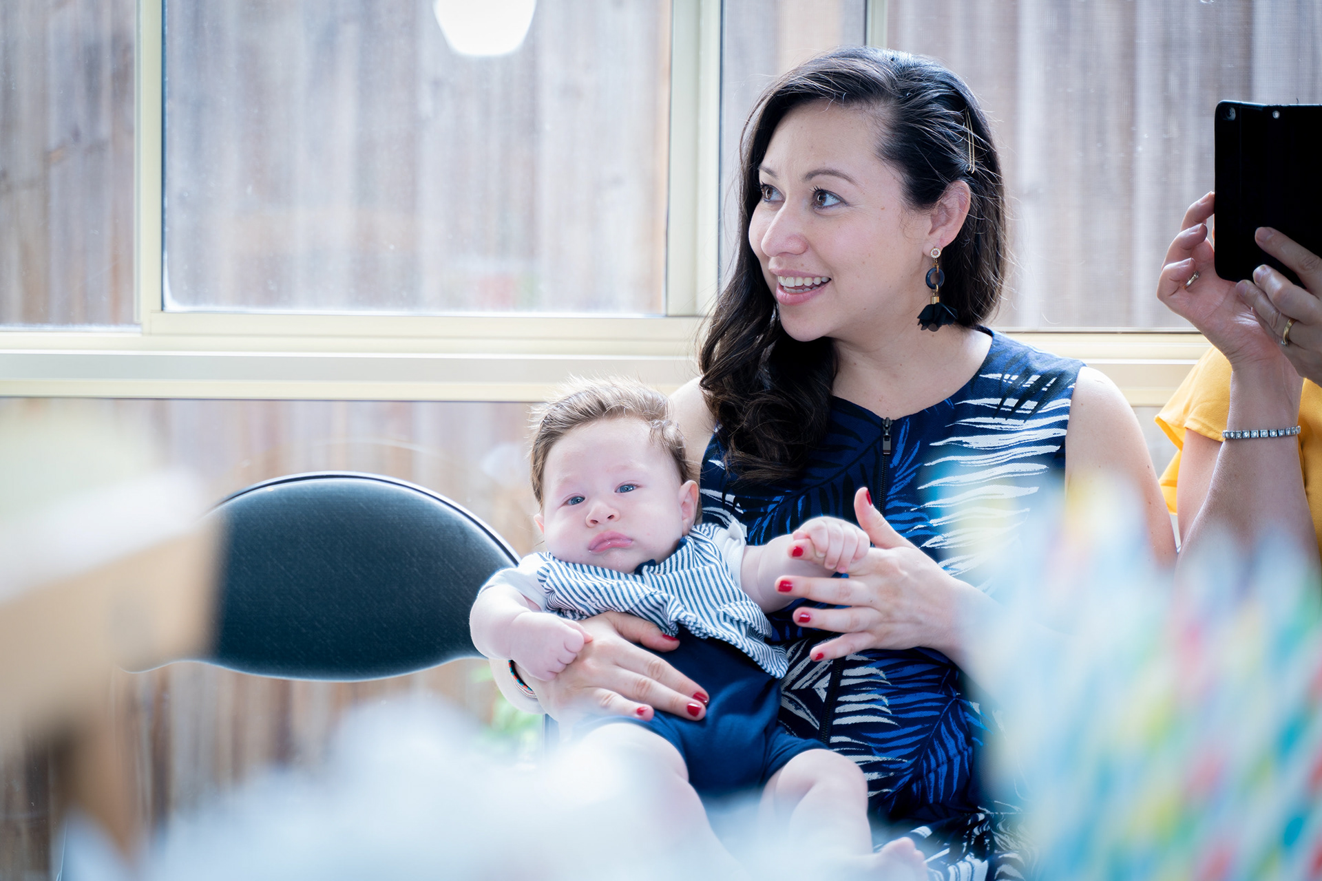 Parent holding a baby indoors