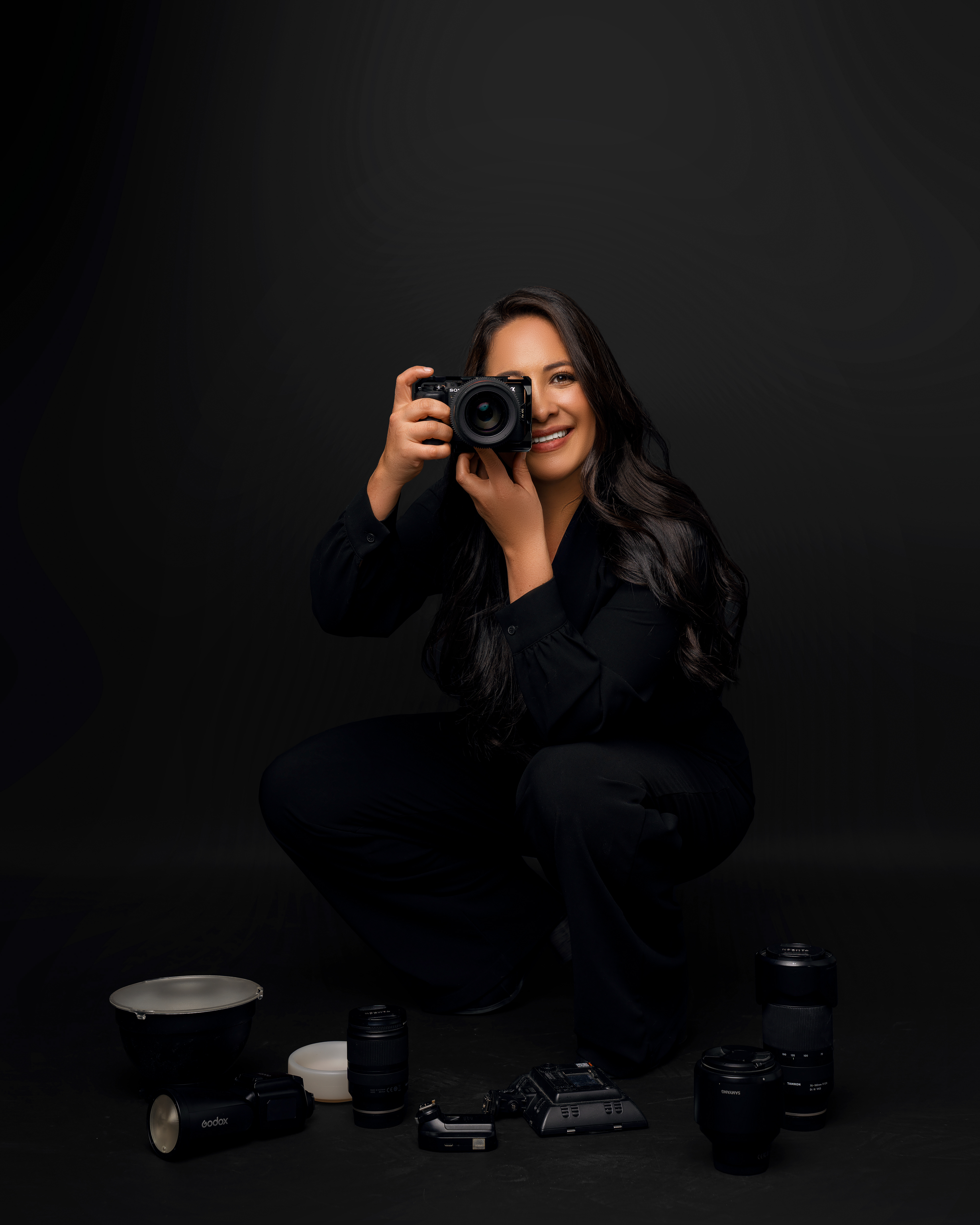 Portrait in a black outfit against a dark background
