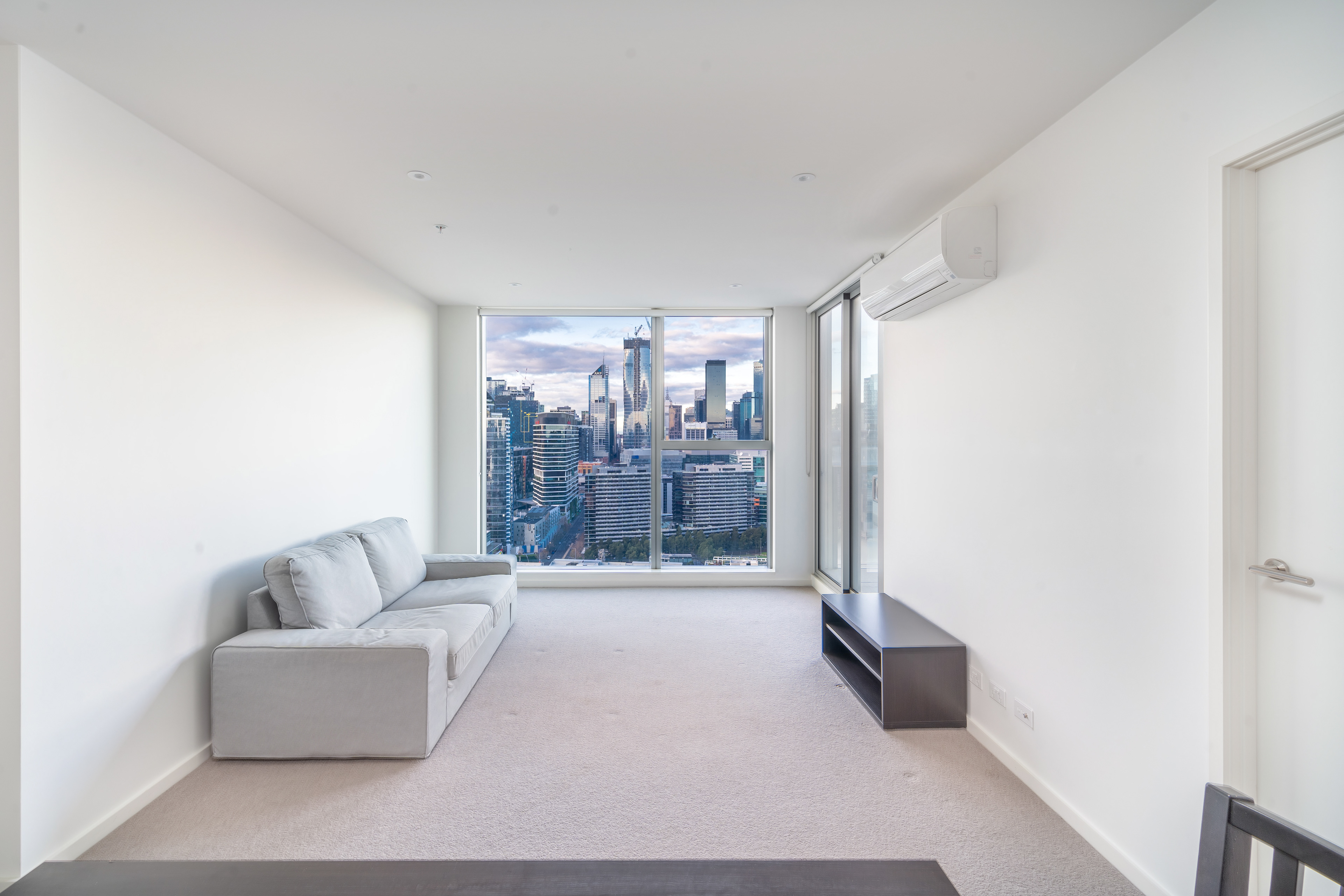 Long living room with a city view at the far end