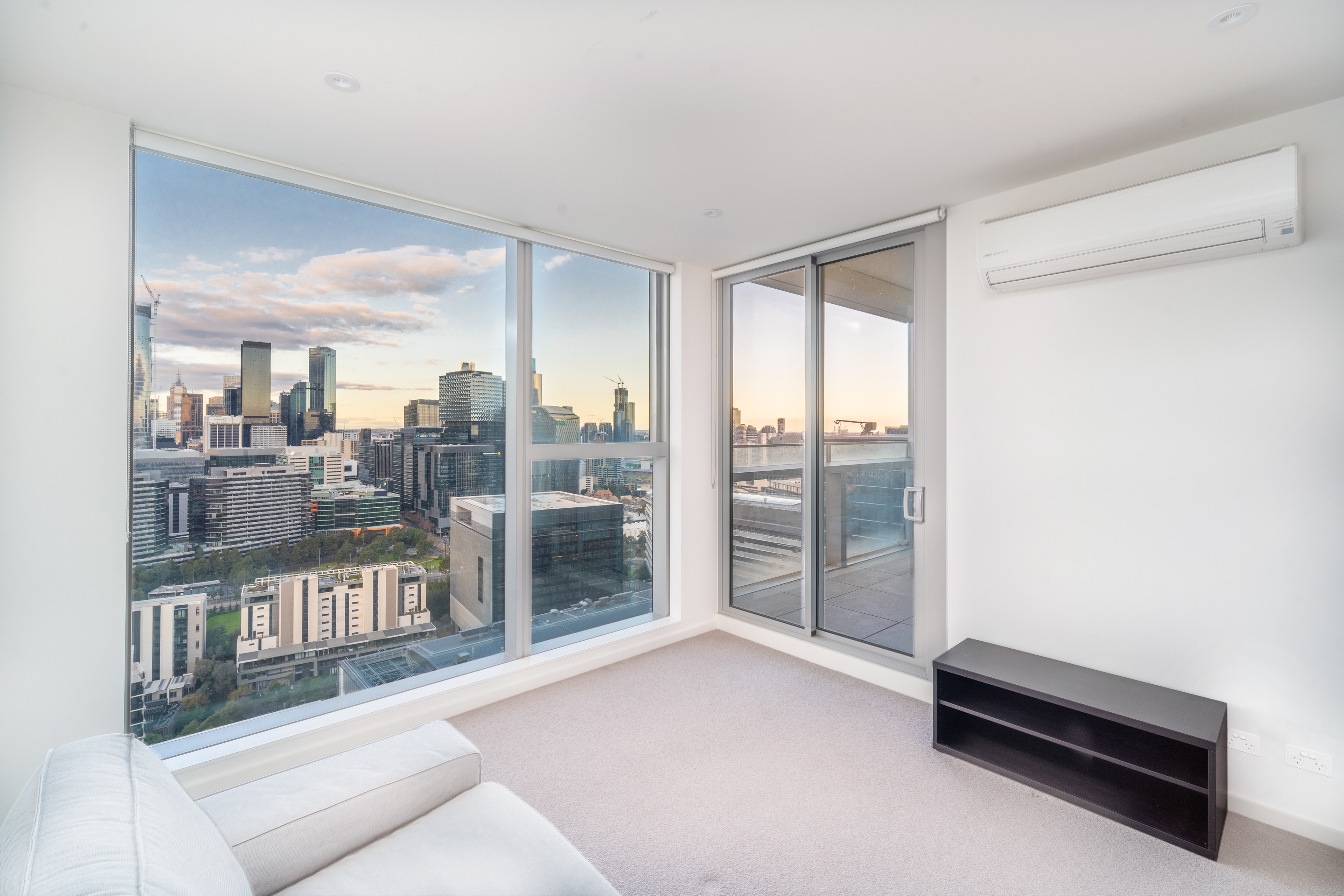 Apartment living room with a white sofa and wide windows