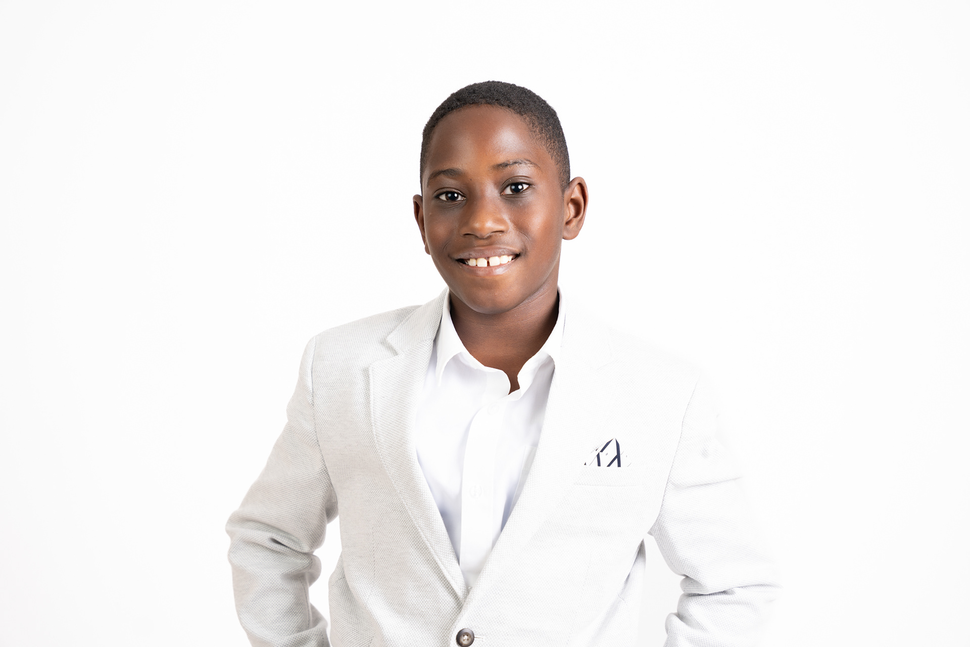 Smiling professional headshot in a white blazer