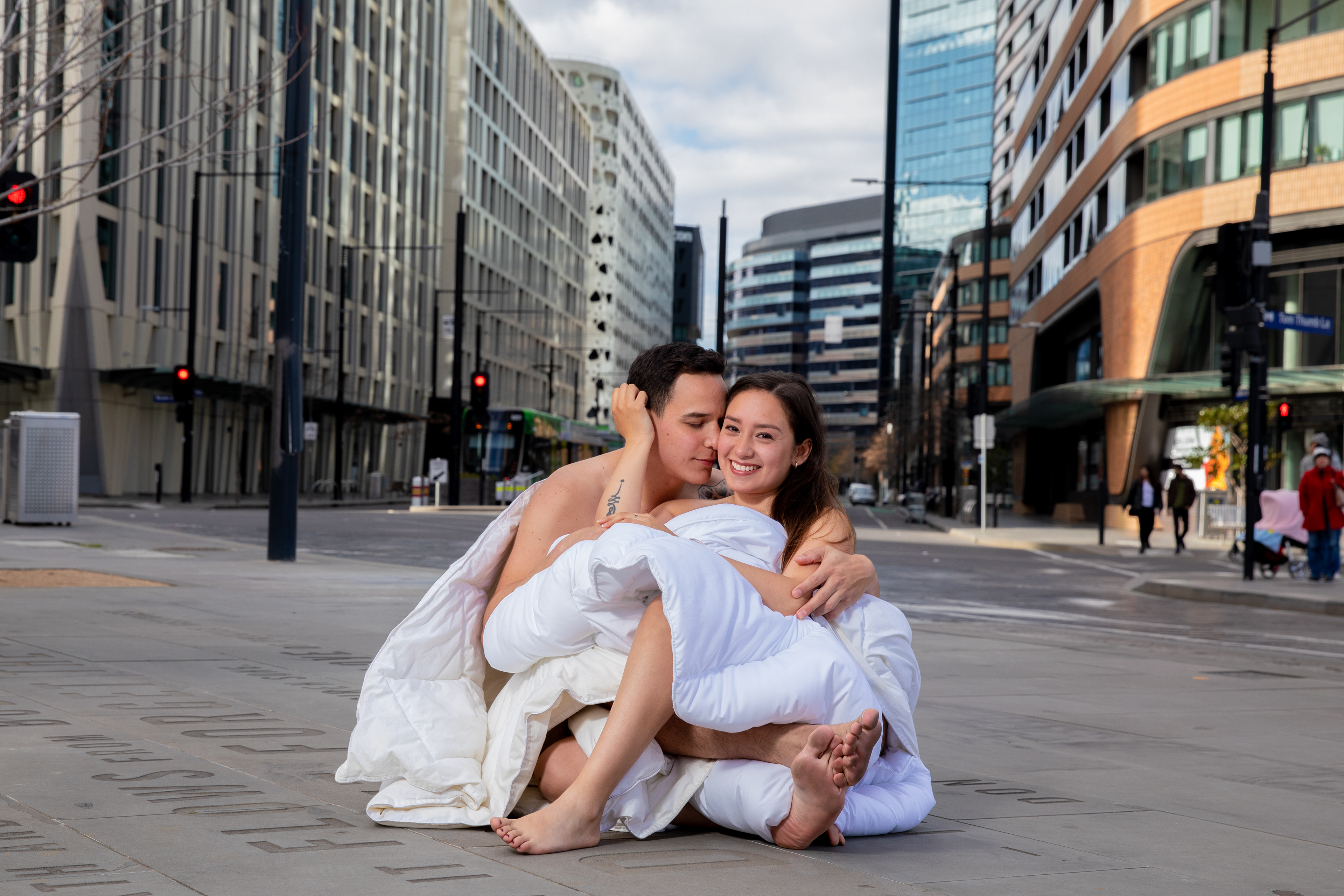 Couple seated together on a city street