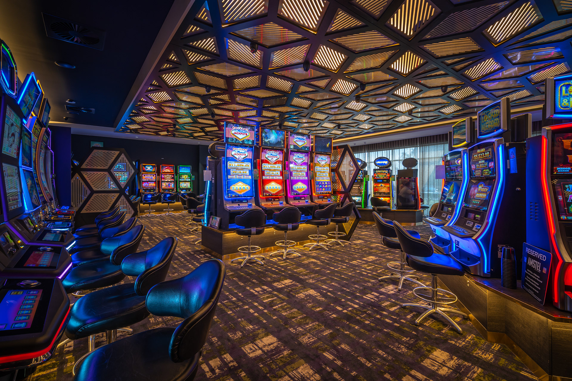 Interior with gaming machines, blue lighting and a patterned ceiling