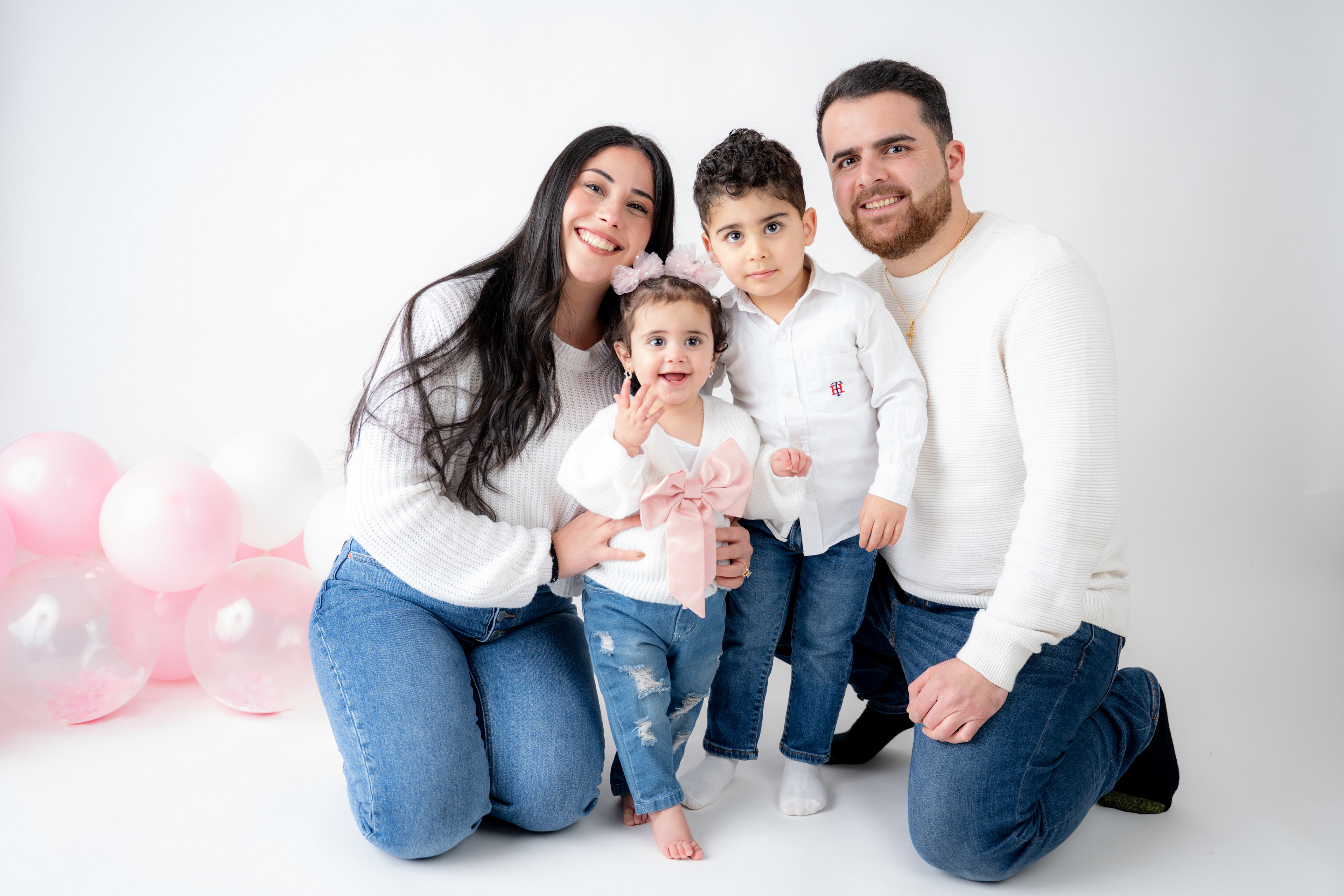 Family seated together in a studio portrait
