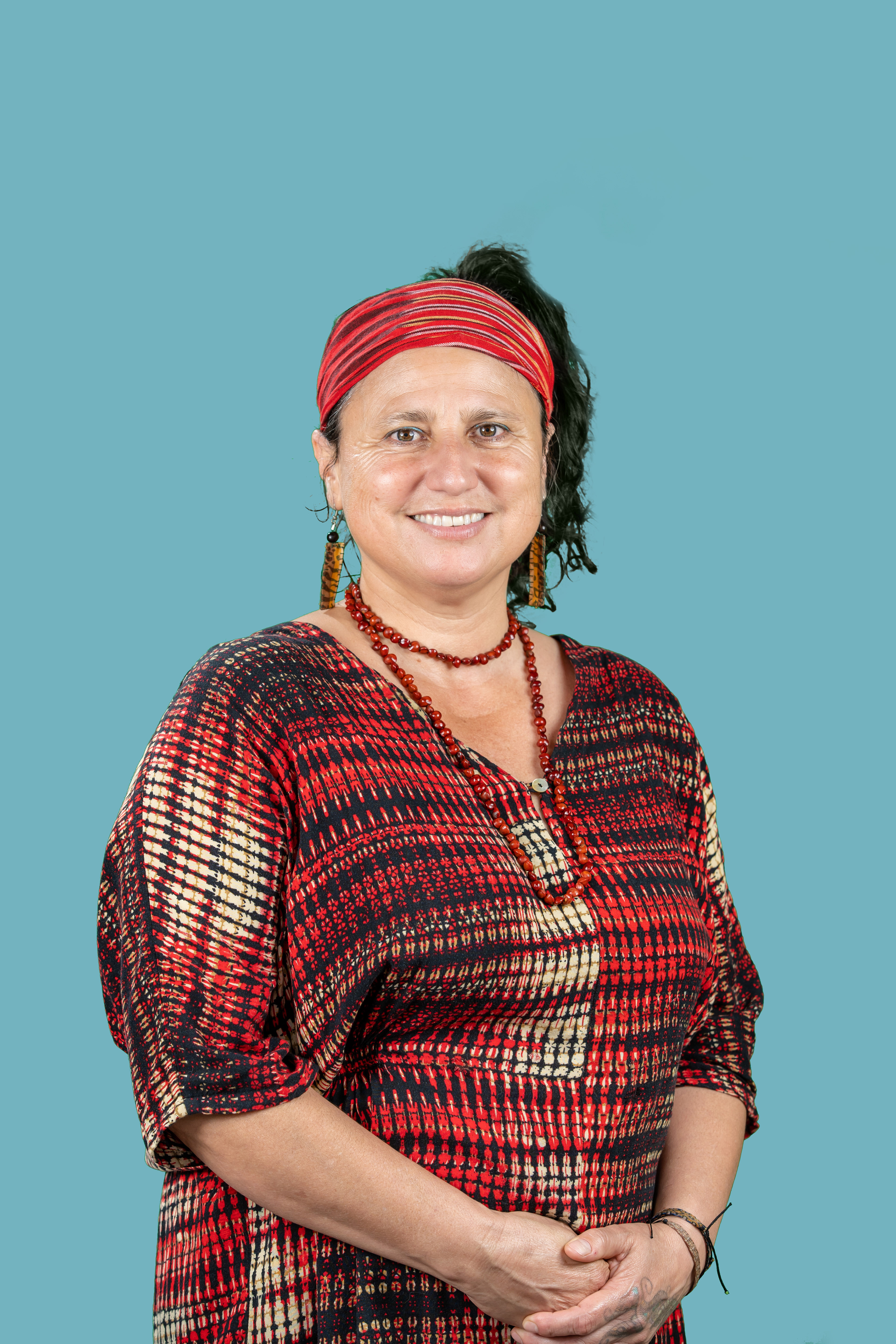 Portrait in a red beret against a turquoise background