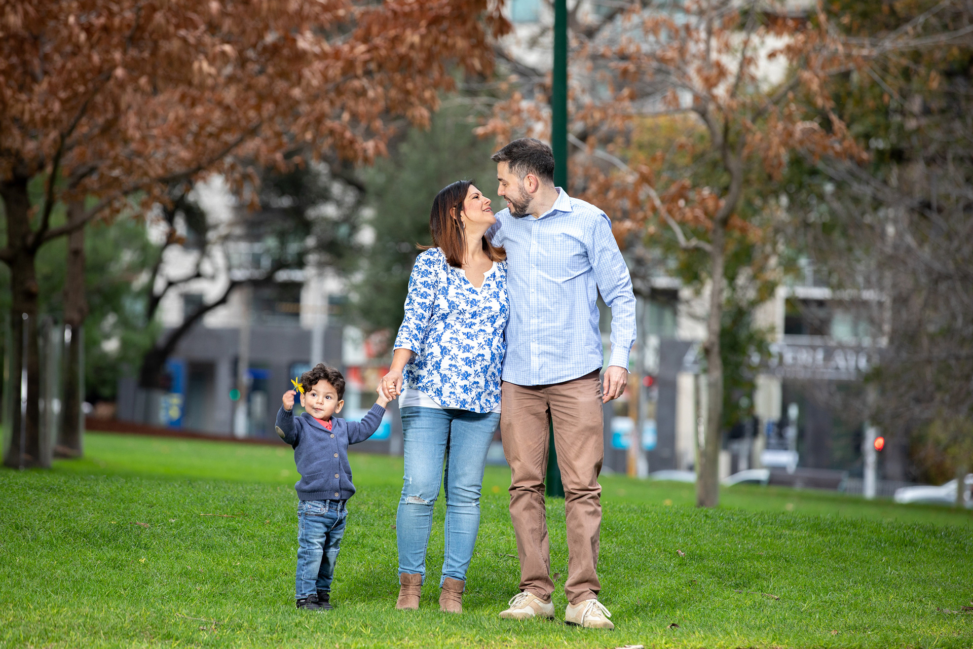 Couple posing together in a park during a maternity session