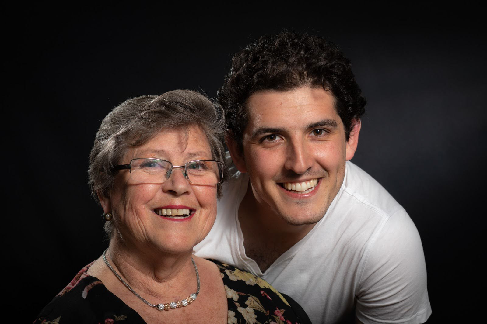 Studio portrait of two adults smiling together
