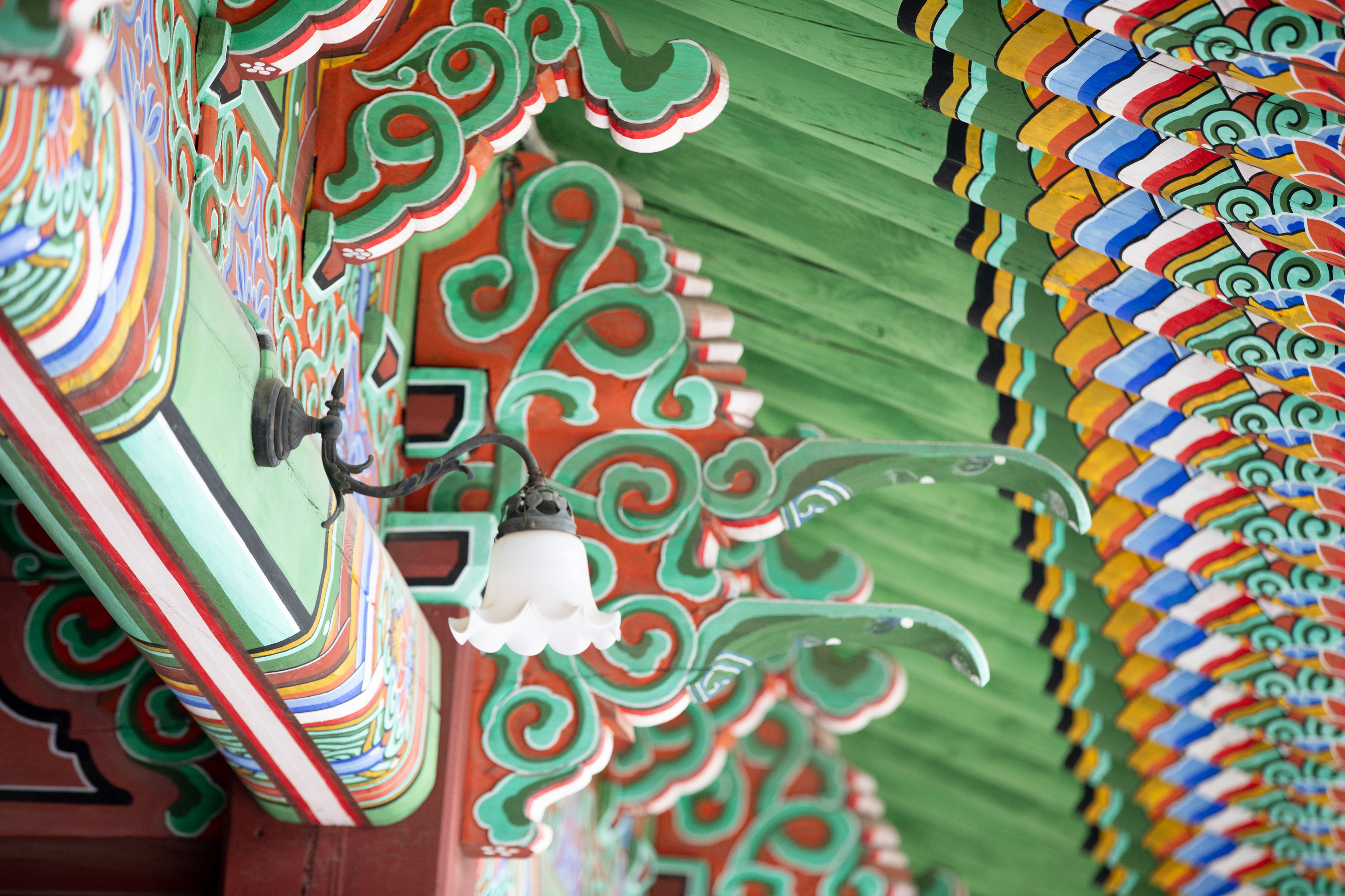 Detail of colourful painted beams beneath a temple roof