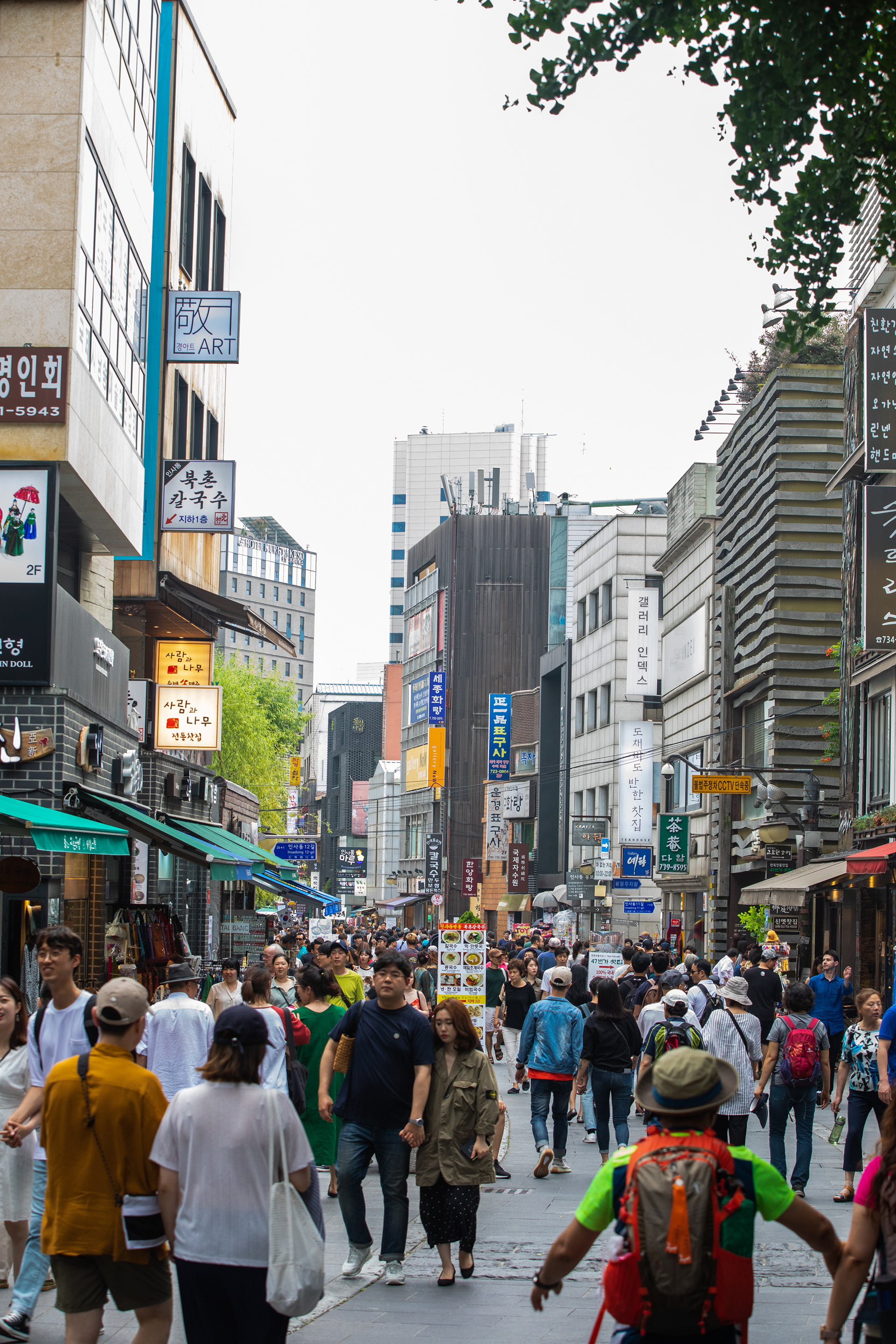 Pedestrians walking along a busy city shopping street