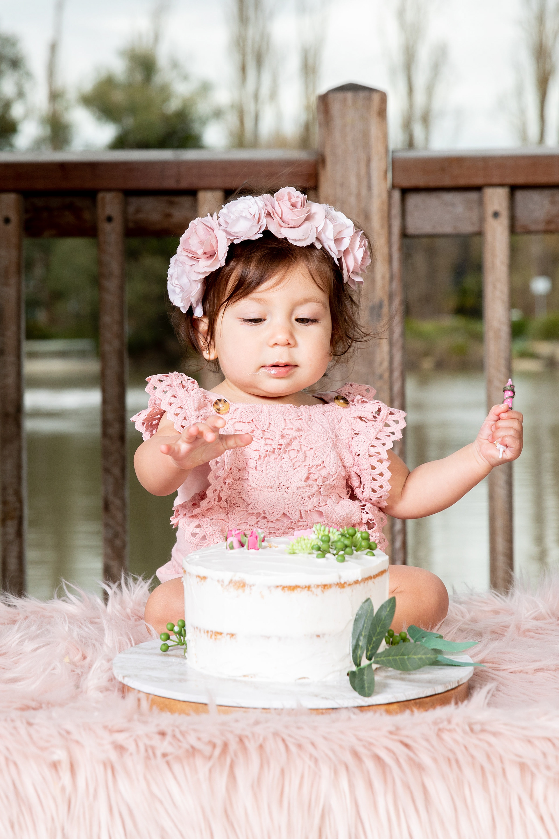 Parent holding a baby at a birthday celebration