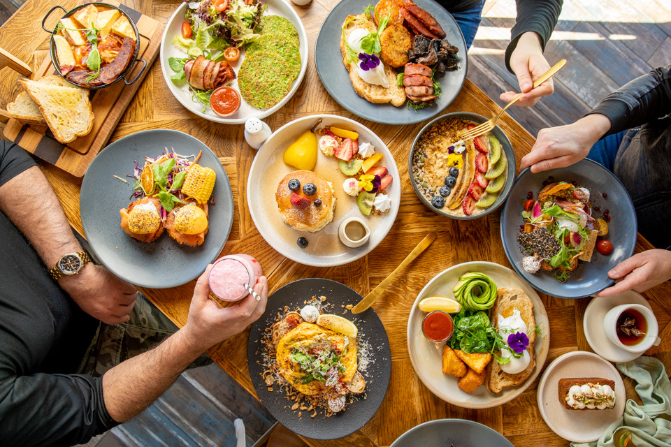 Overhead view of a shared meal with colourful dishes