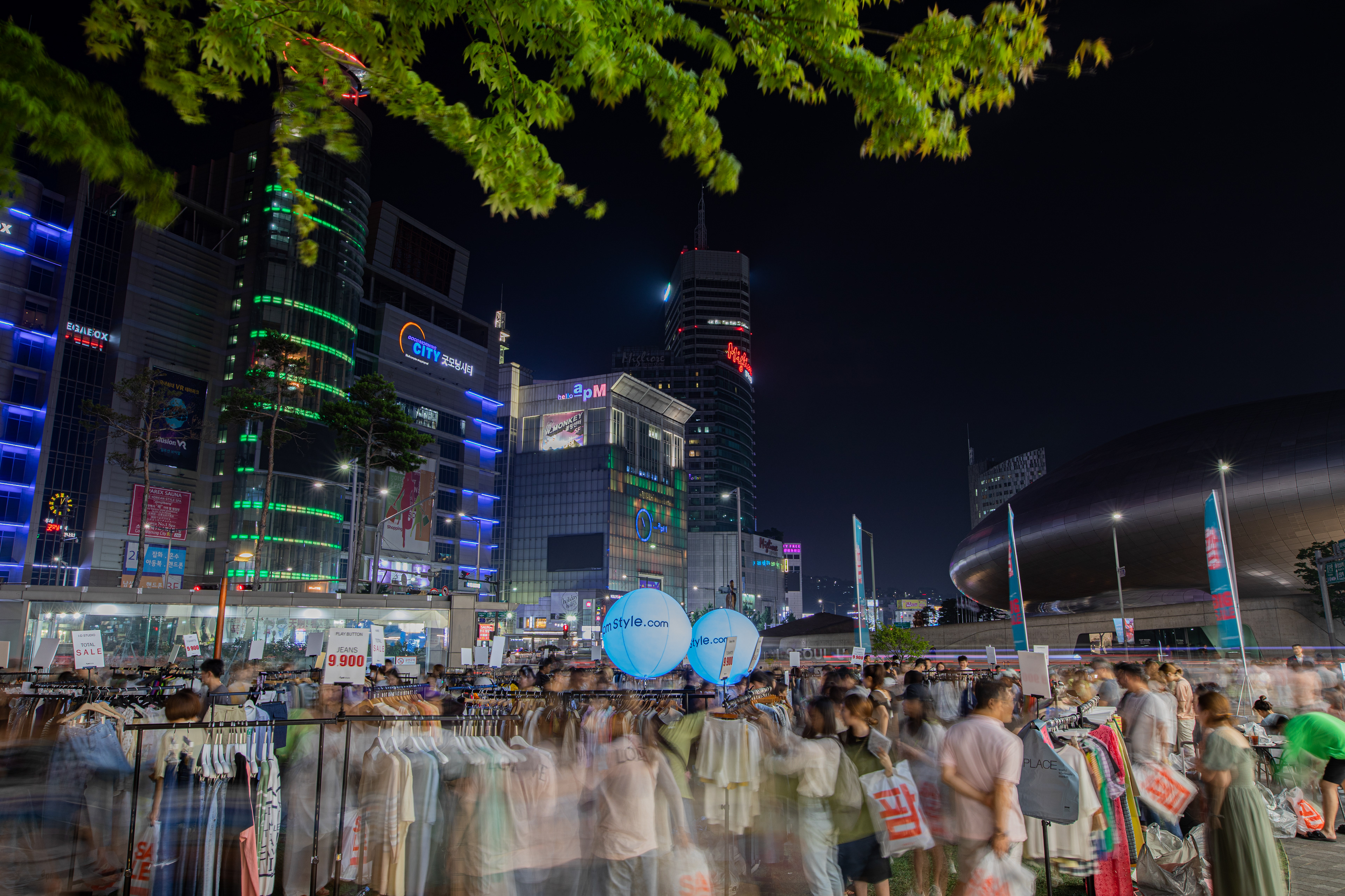 City lights above market stalls at night