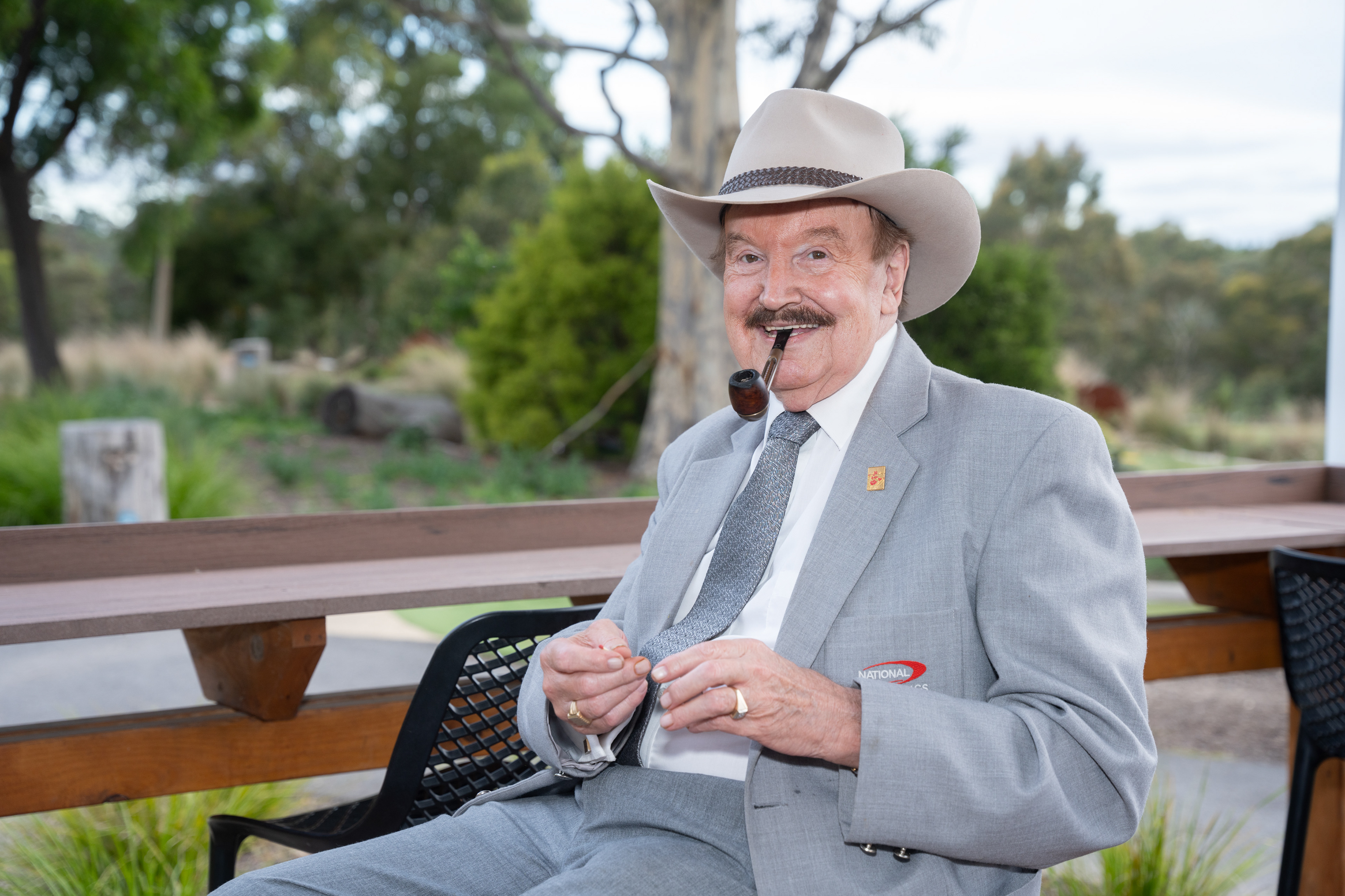 Guest wearing a cowboy hat and holding a drink outdoors
