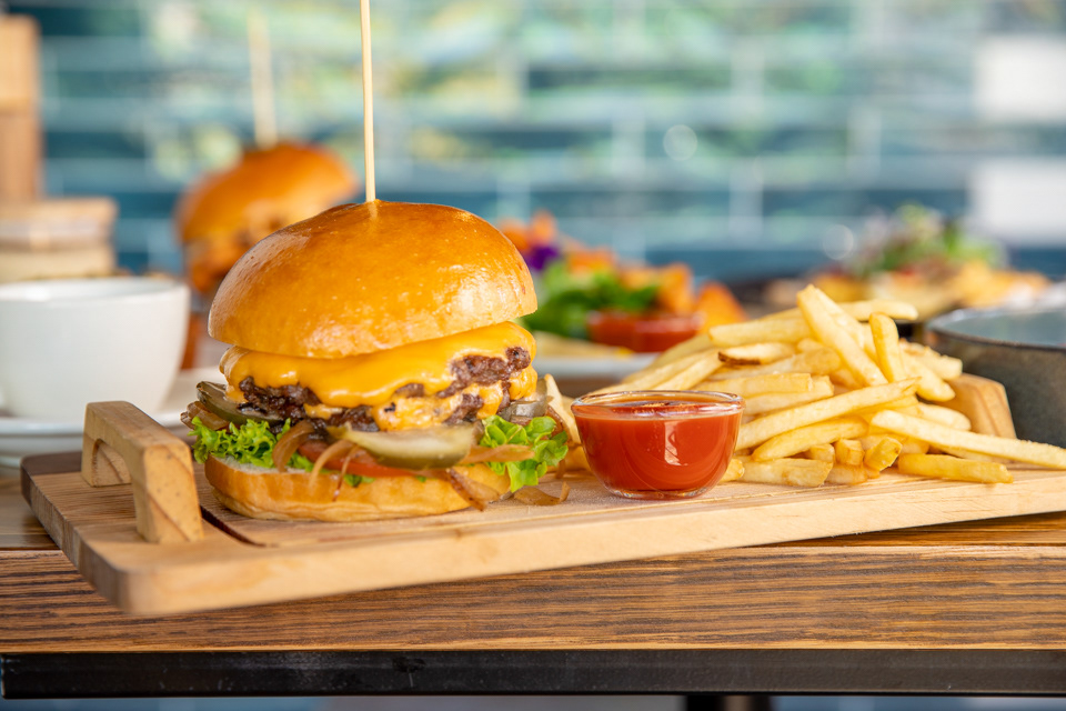 Burgers and fries served on a wooden board