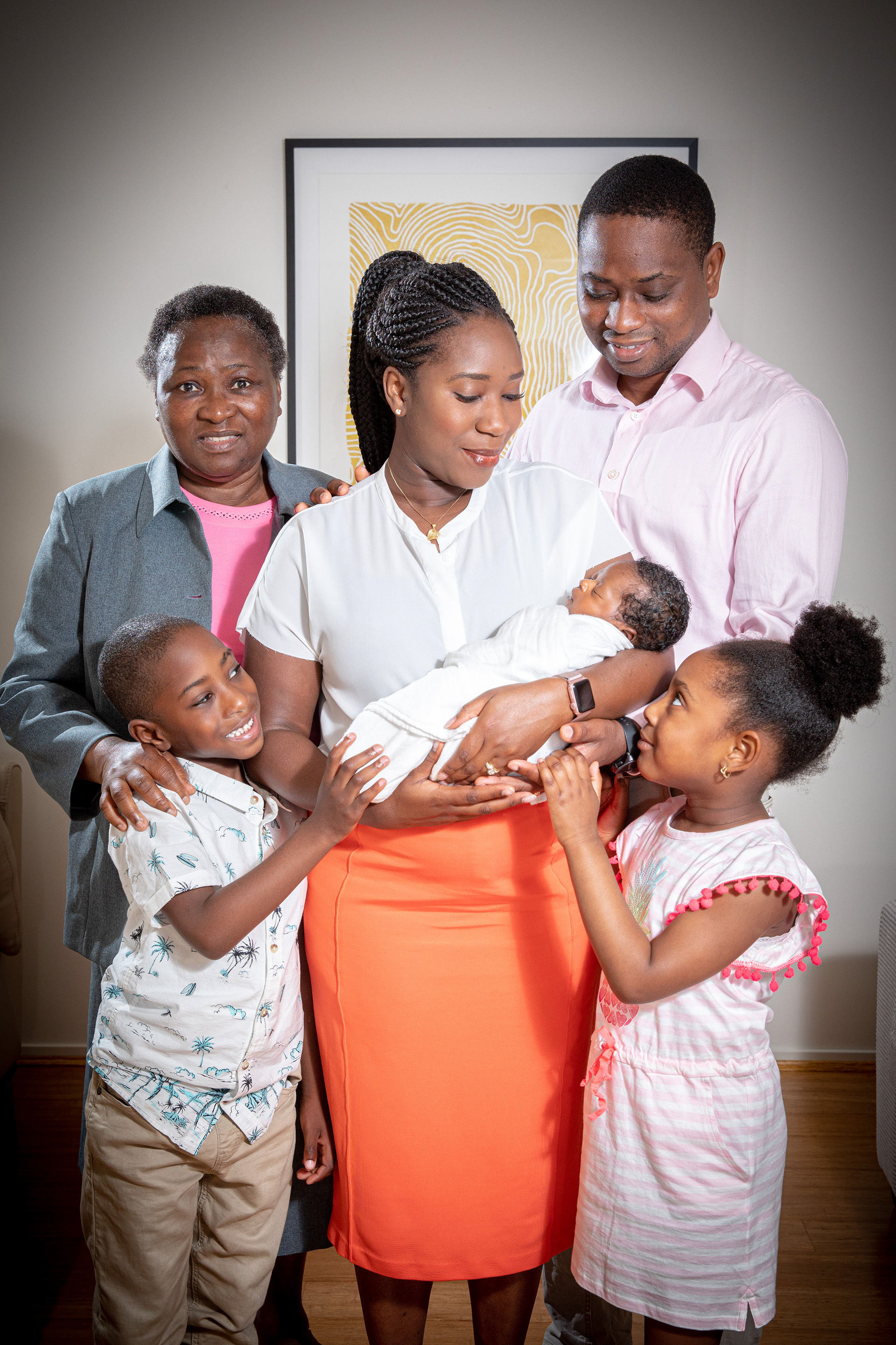 Family standing together with a newborn baby