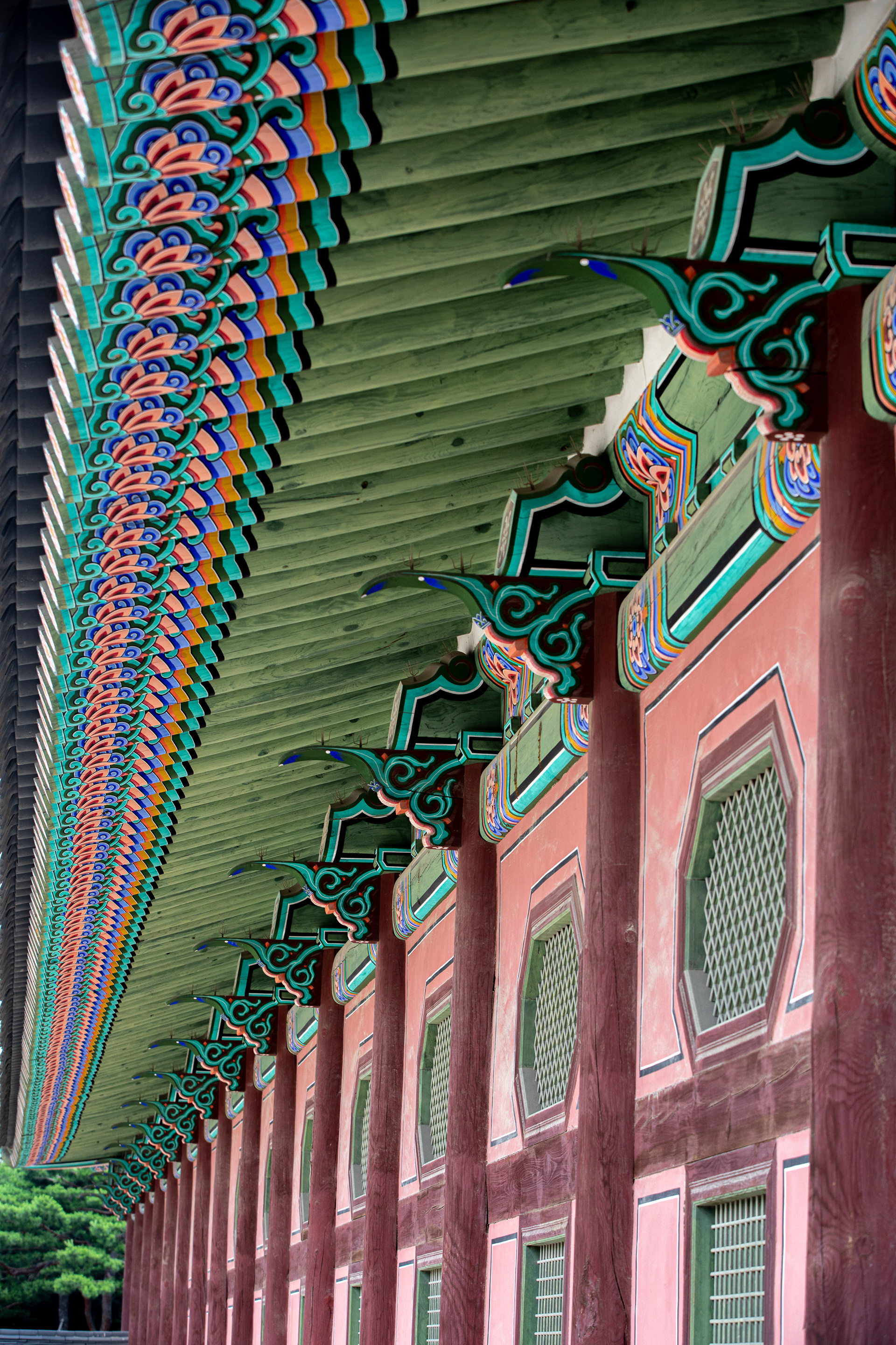 Painted wooden pillars along a traditional corridor