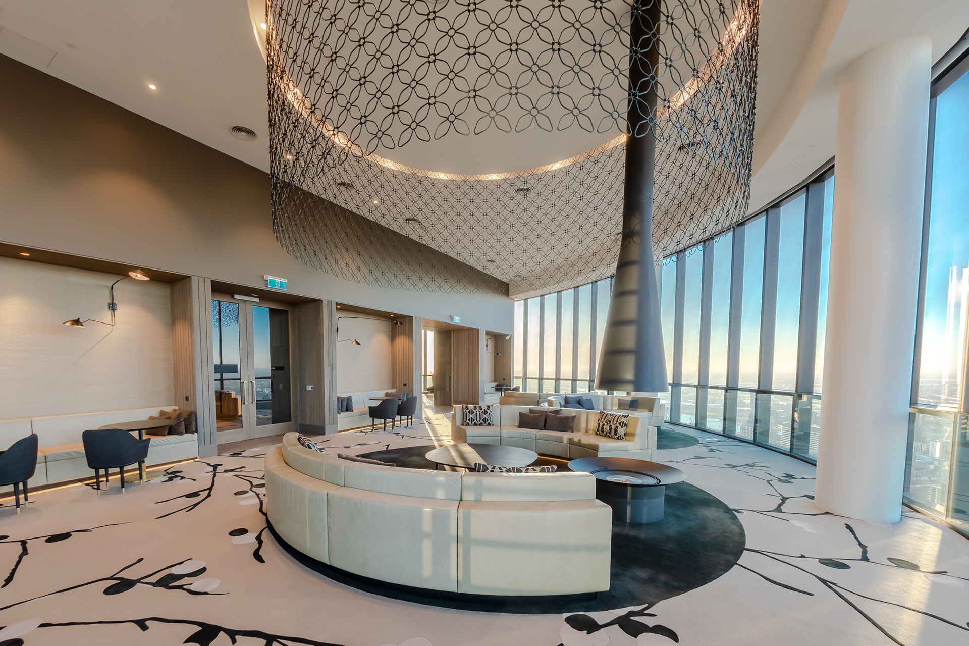 Spacious lounge with a sculptural ceiling light and city views