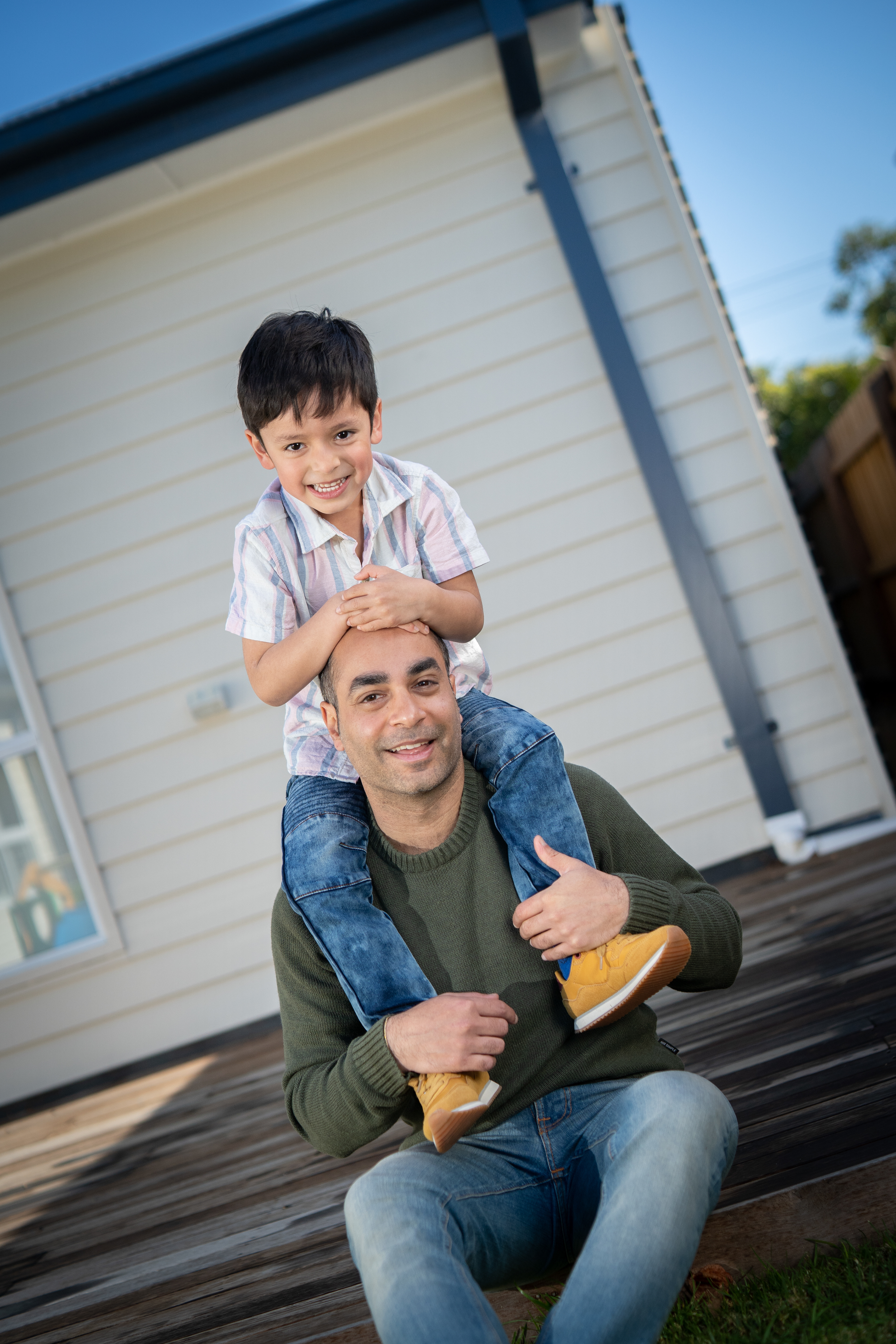 Child standing beside a cot at home