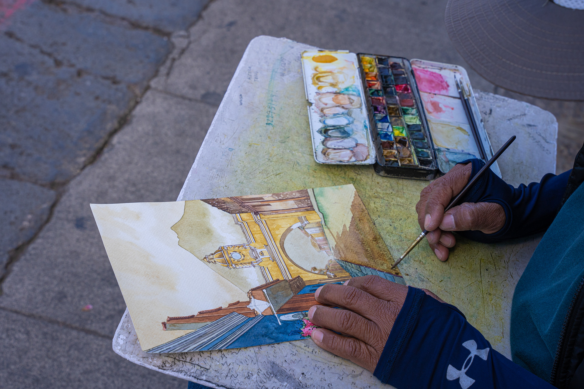 Artist drawing and painting on paper
