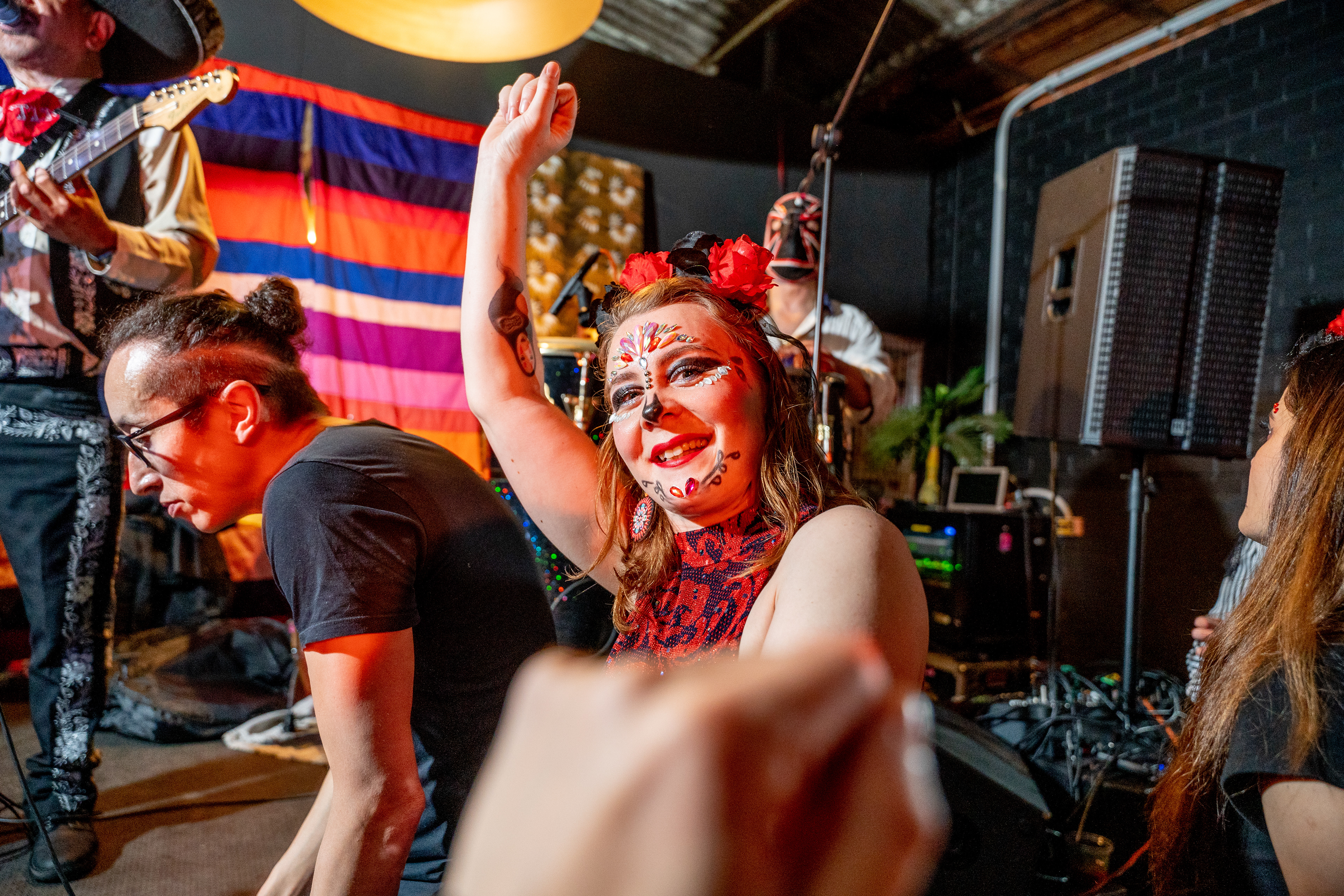 Guests dancing beneath colourful decorations