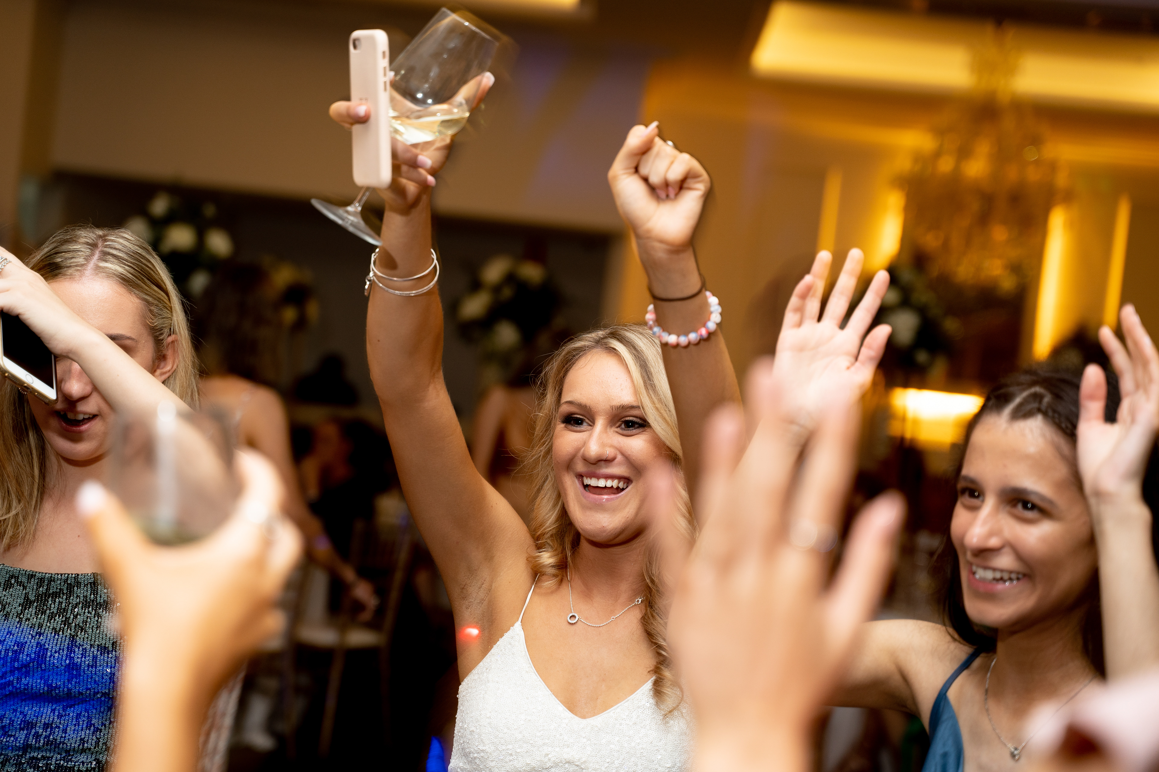 Guests raising their hands on a dance floor
