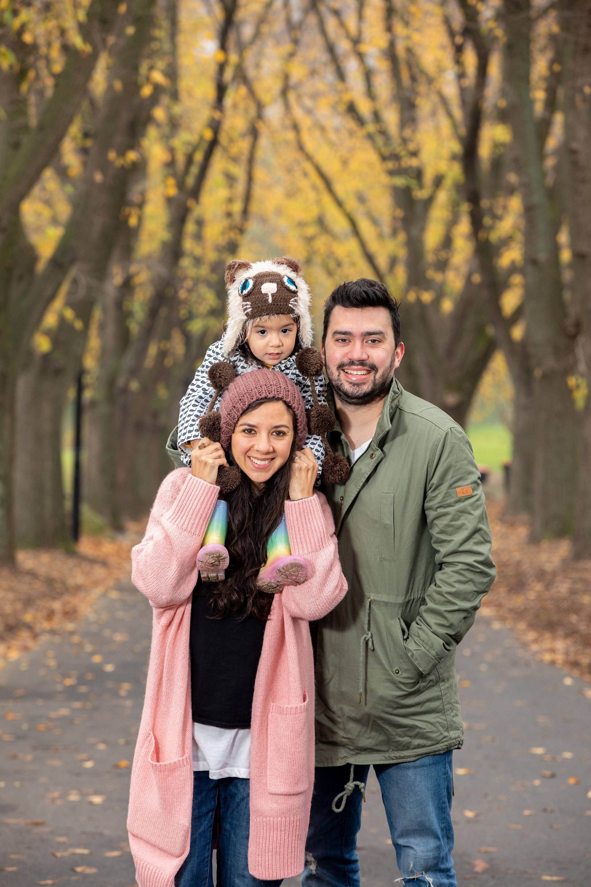 Couple standing together beneath autumn trees