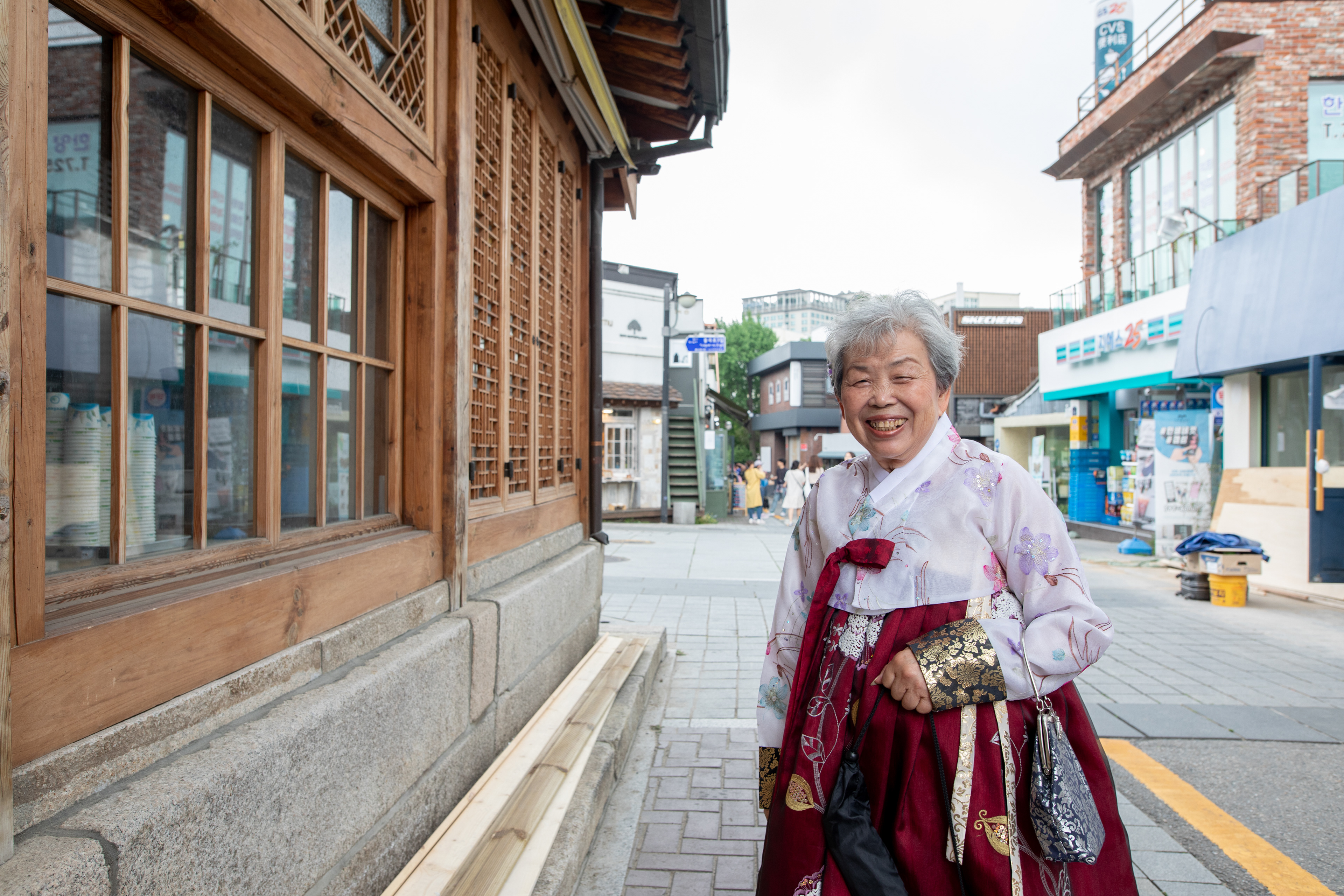 Portrait outside a traditional wooden shopfront