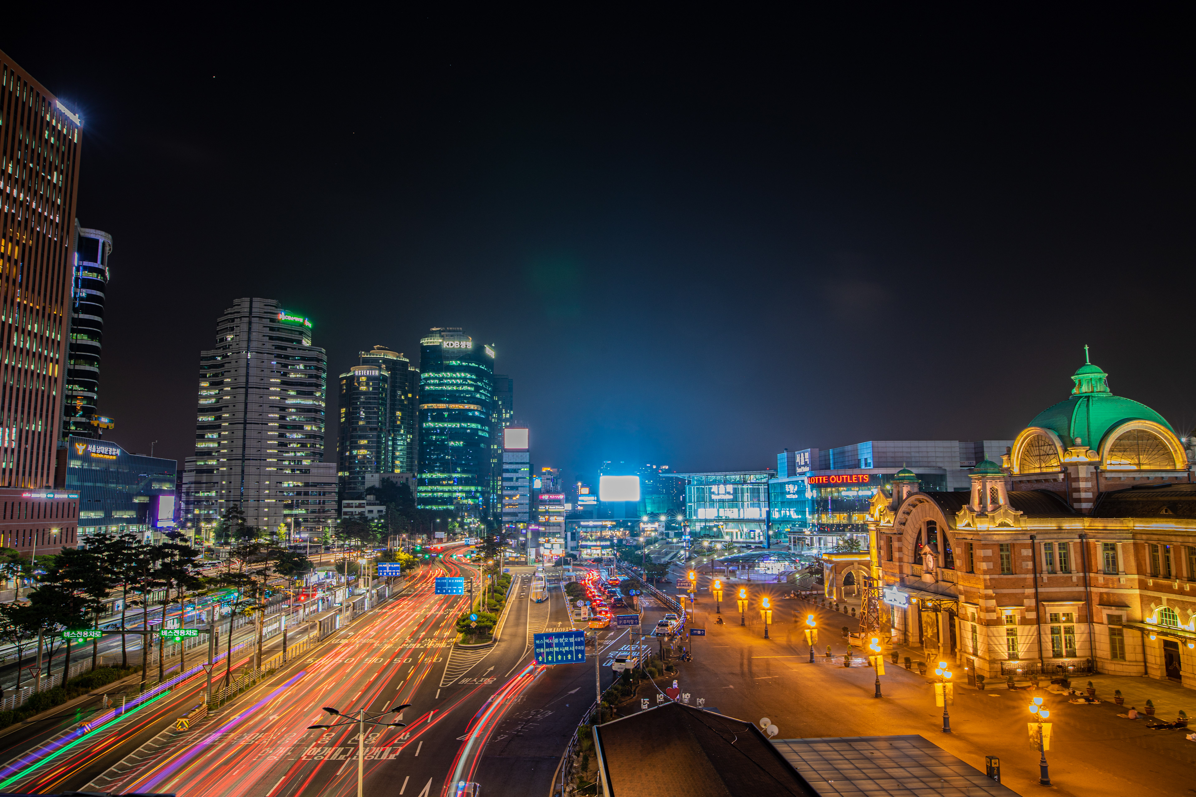 Illuminated station building and traffic after dark