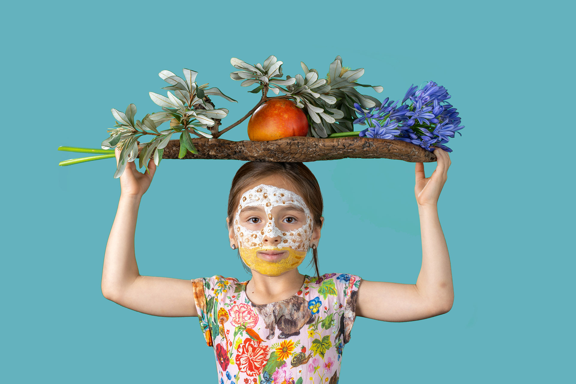 Portrait holding a large frame decorated with flowers