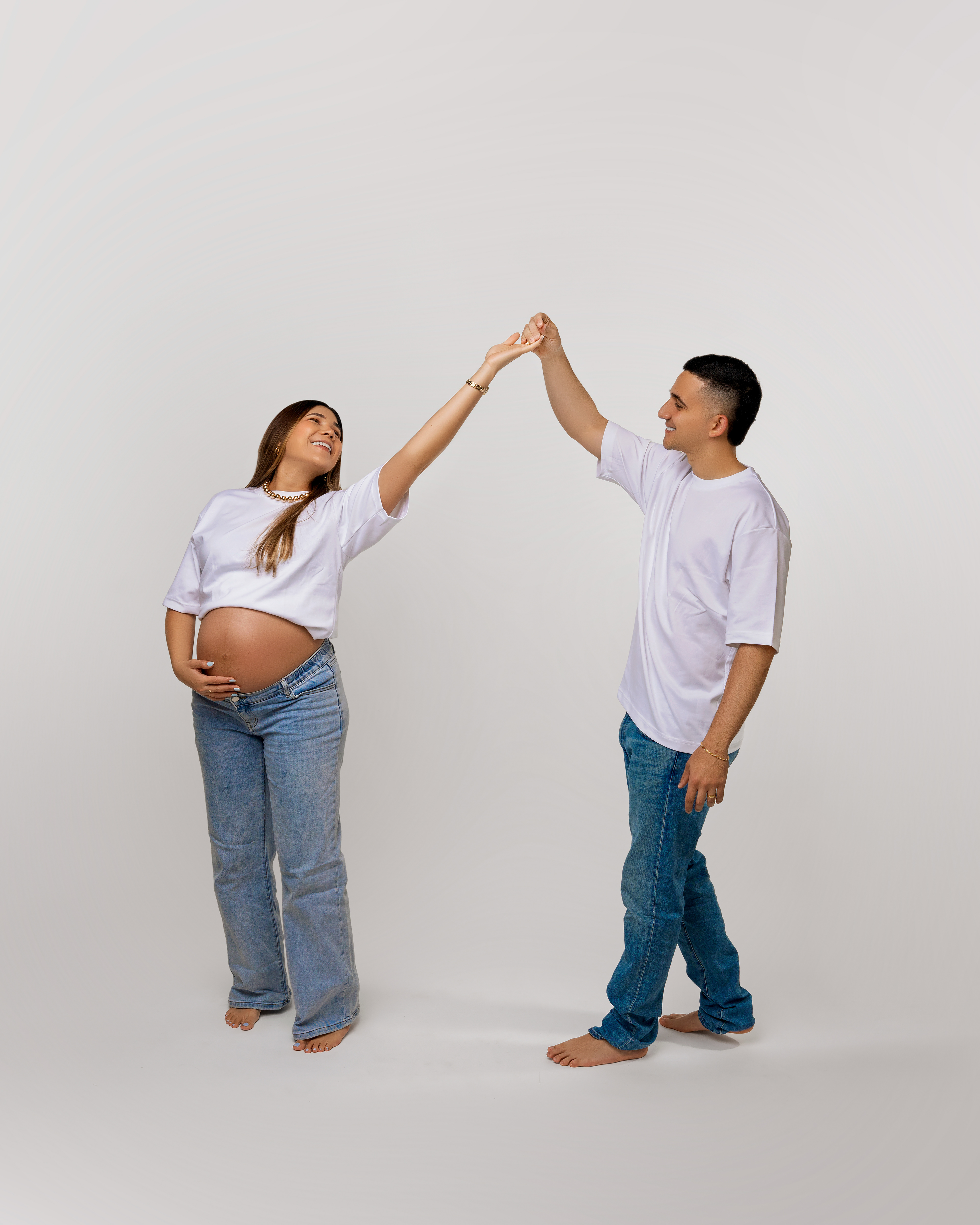 Two people in white tops giving each other a high five